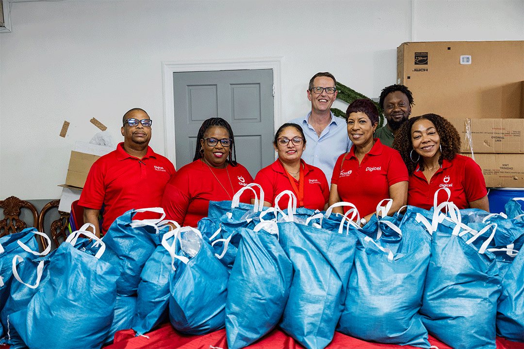 Digicel Staff in front of hampers