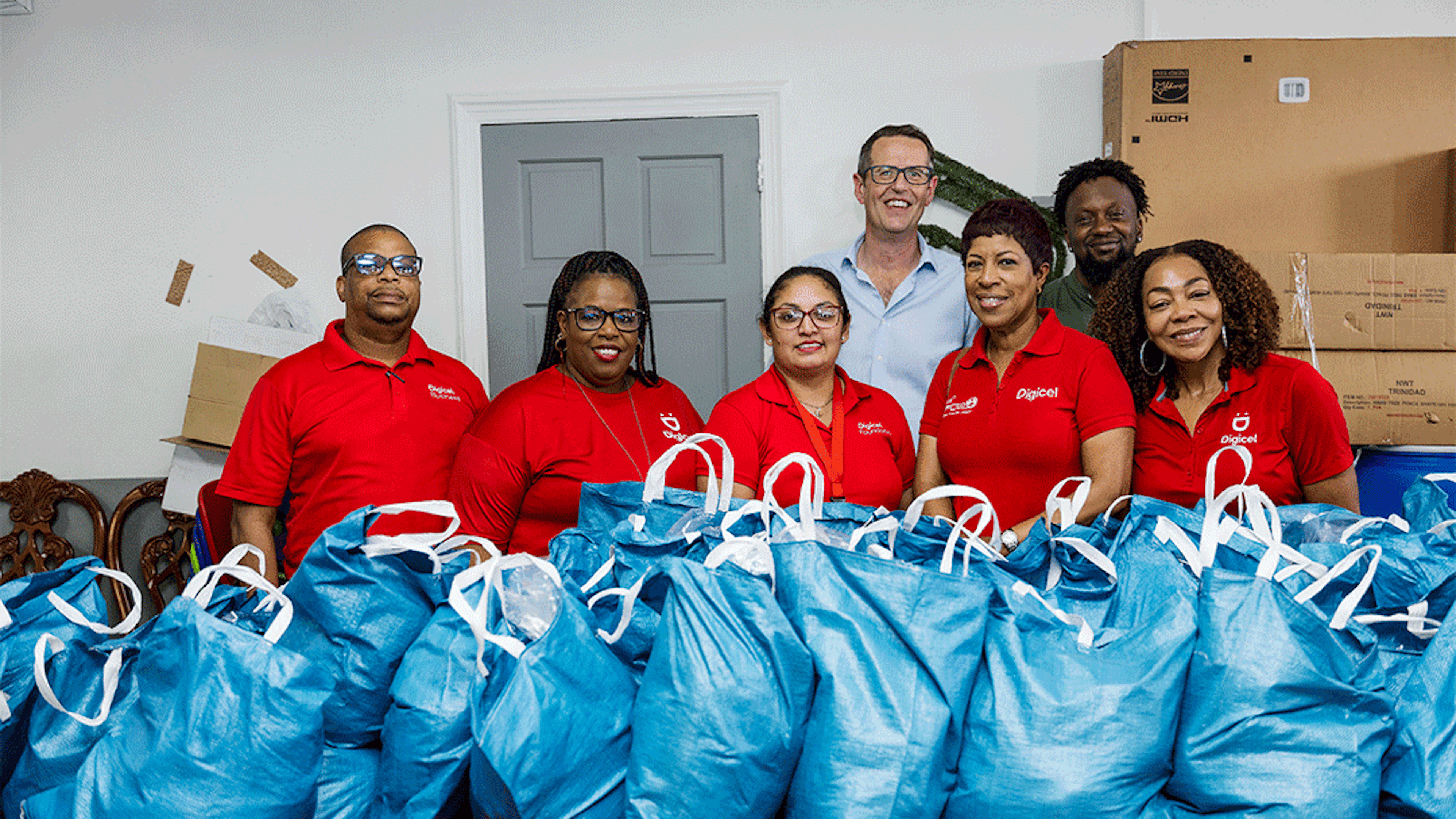 Digicel Staff in front of hampers