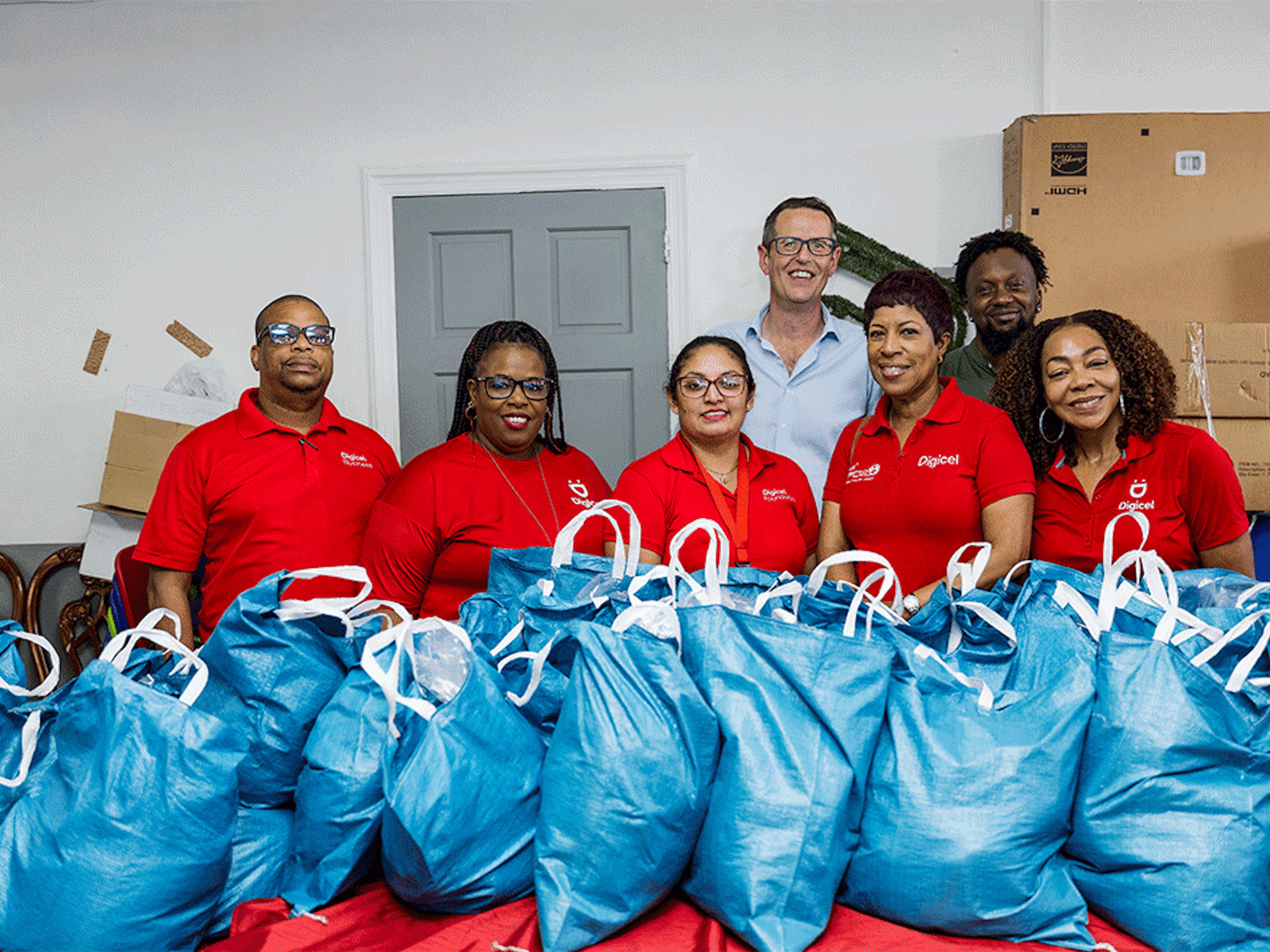 Digicel Staff in front of hampers