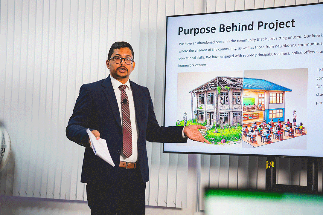 man in suit delivering a presentation