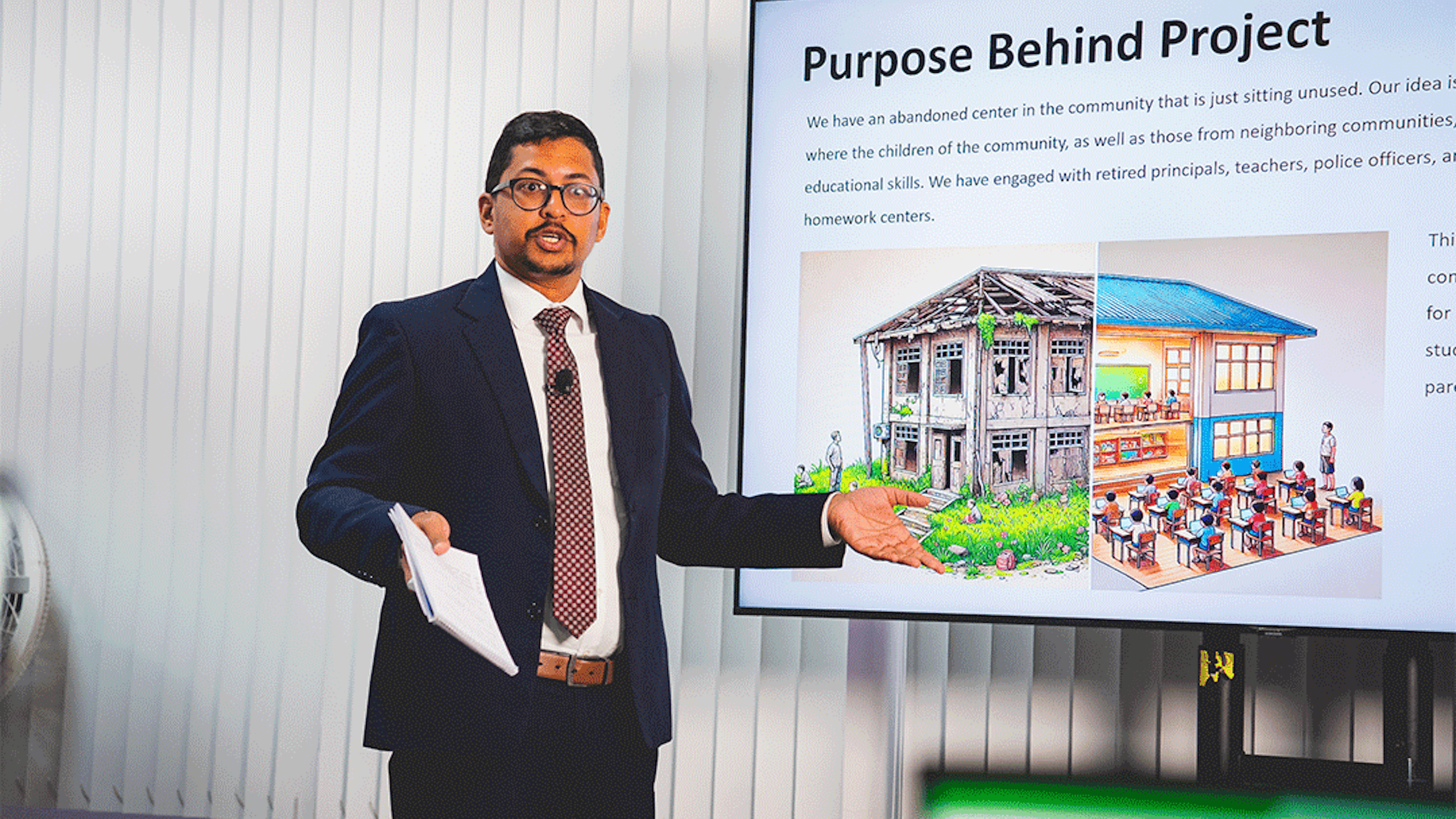 man in suit delivering a presentation