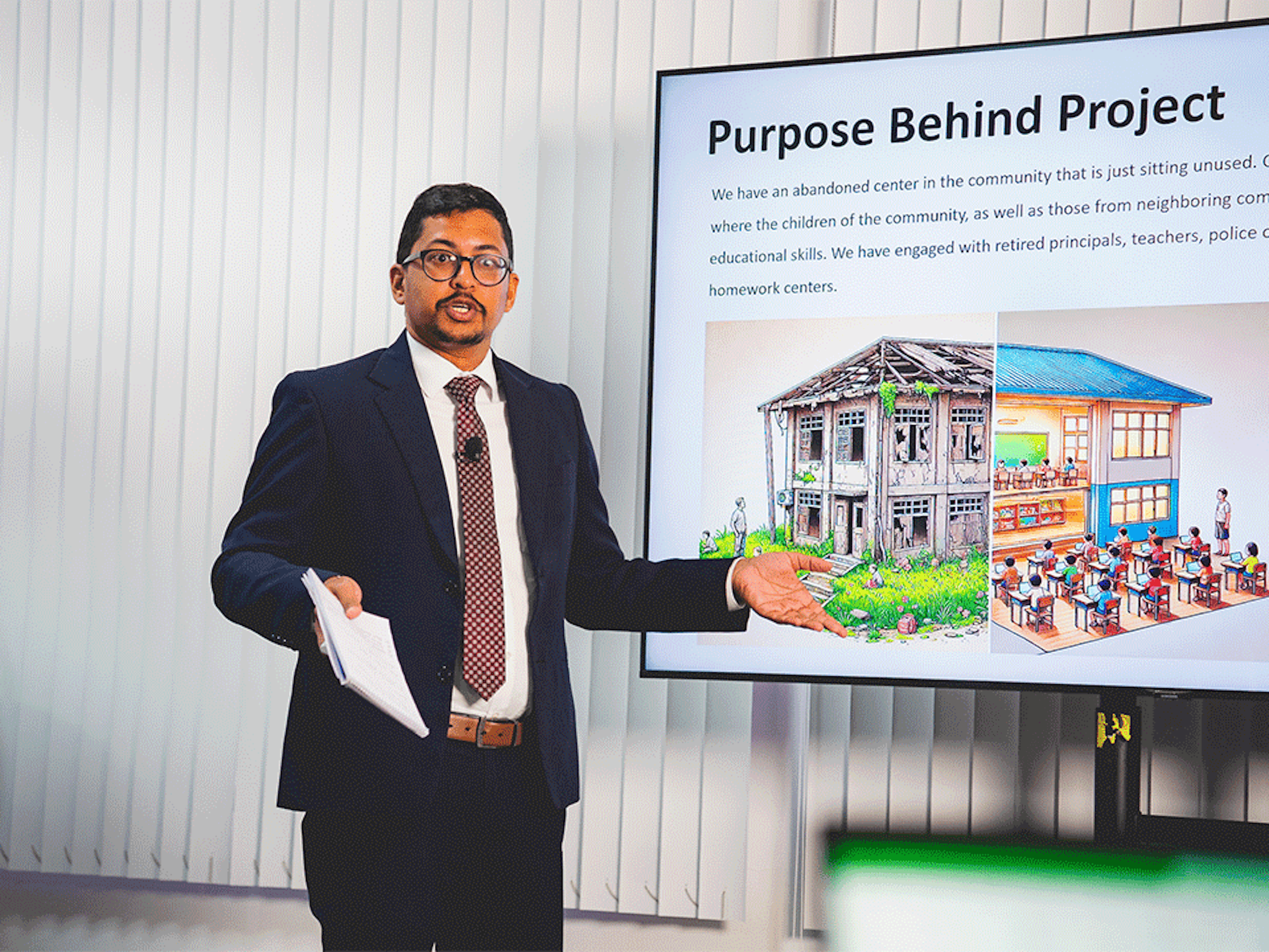 man in suit delivering a presentation