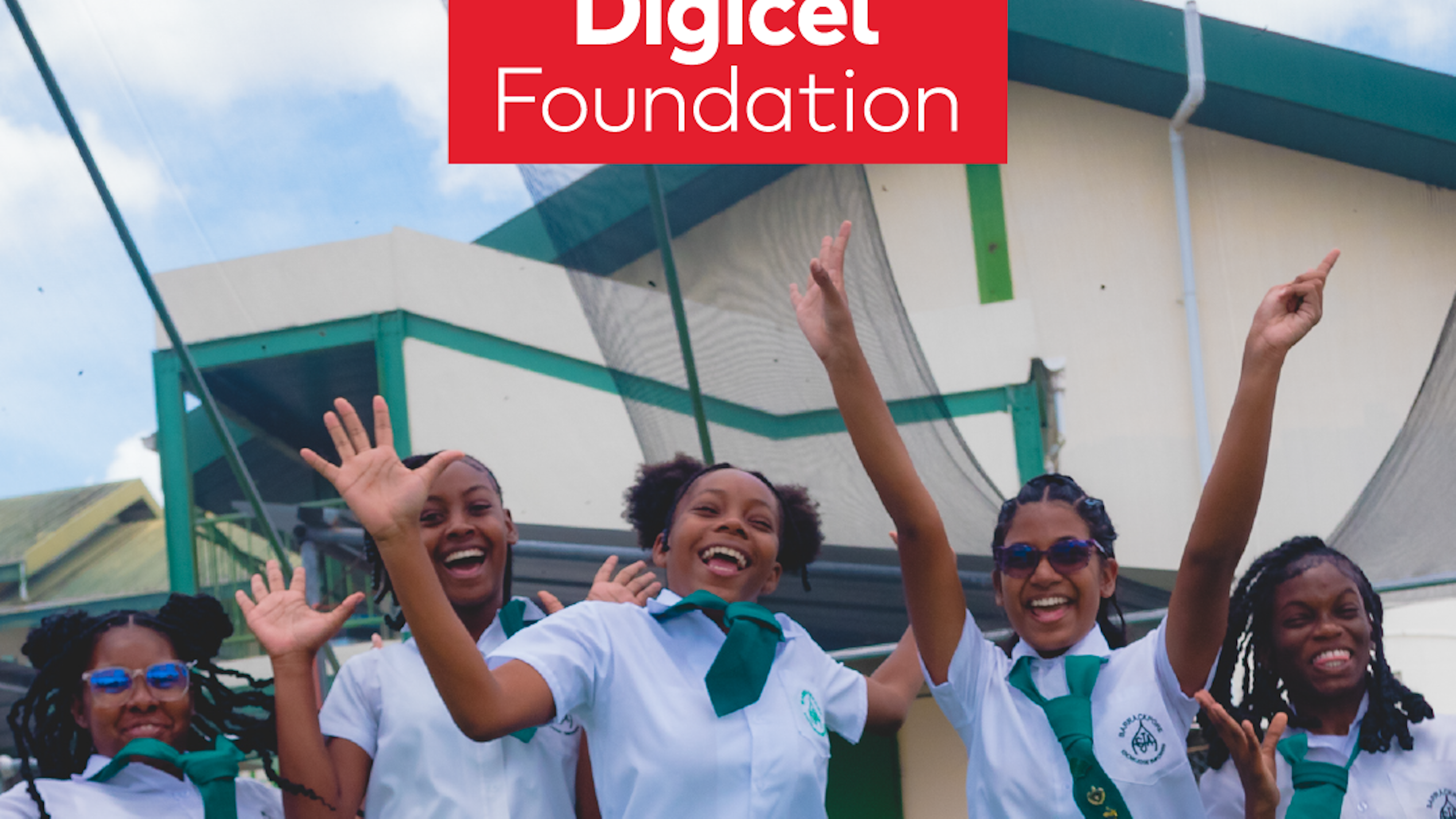 school girls jumping in front of hydroponics