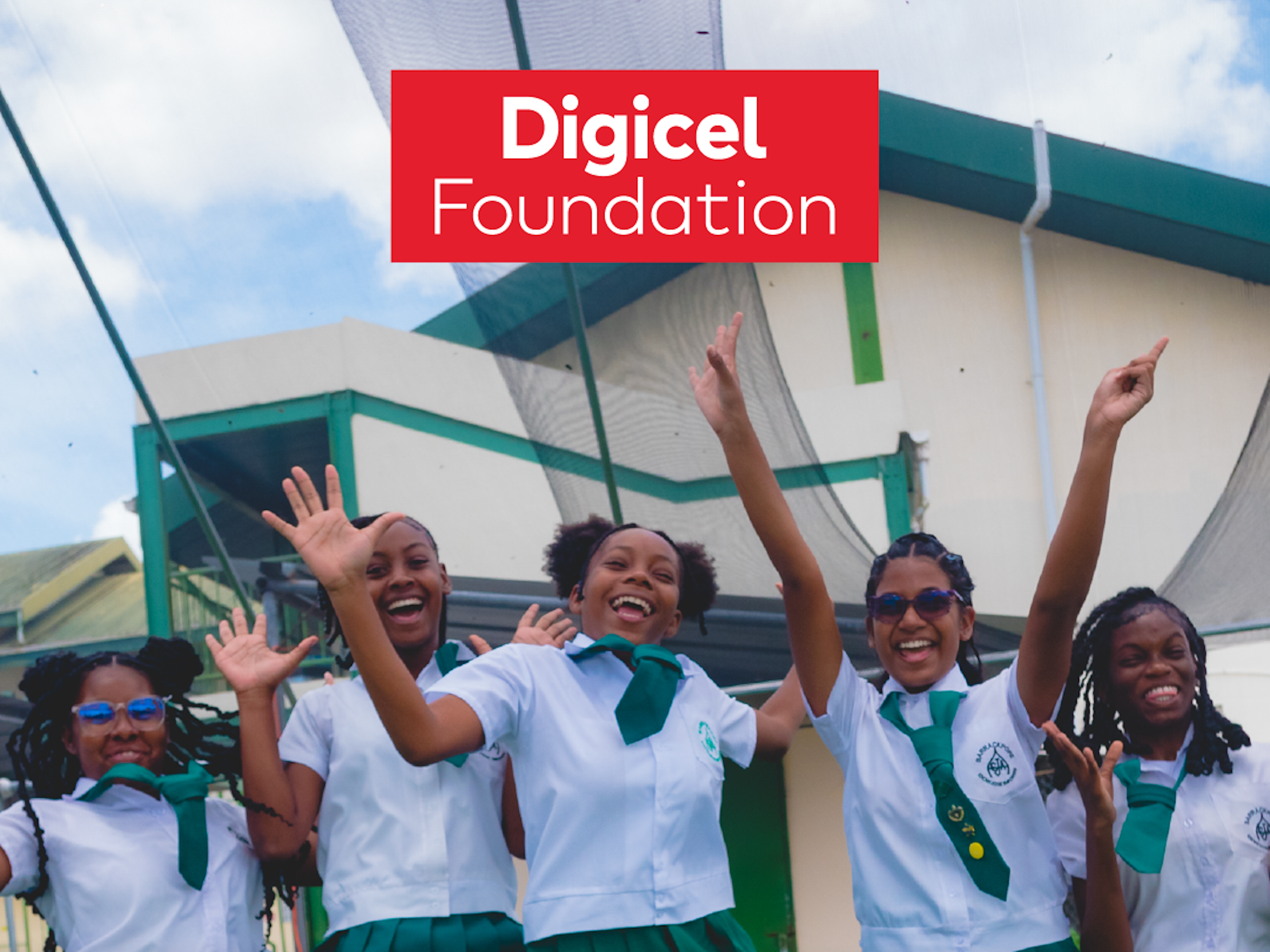 school girls jumping in front of hydroponics