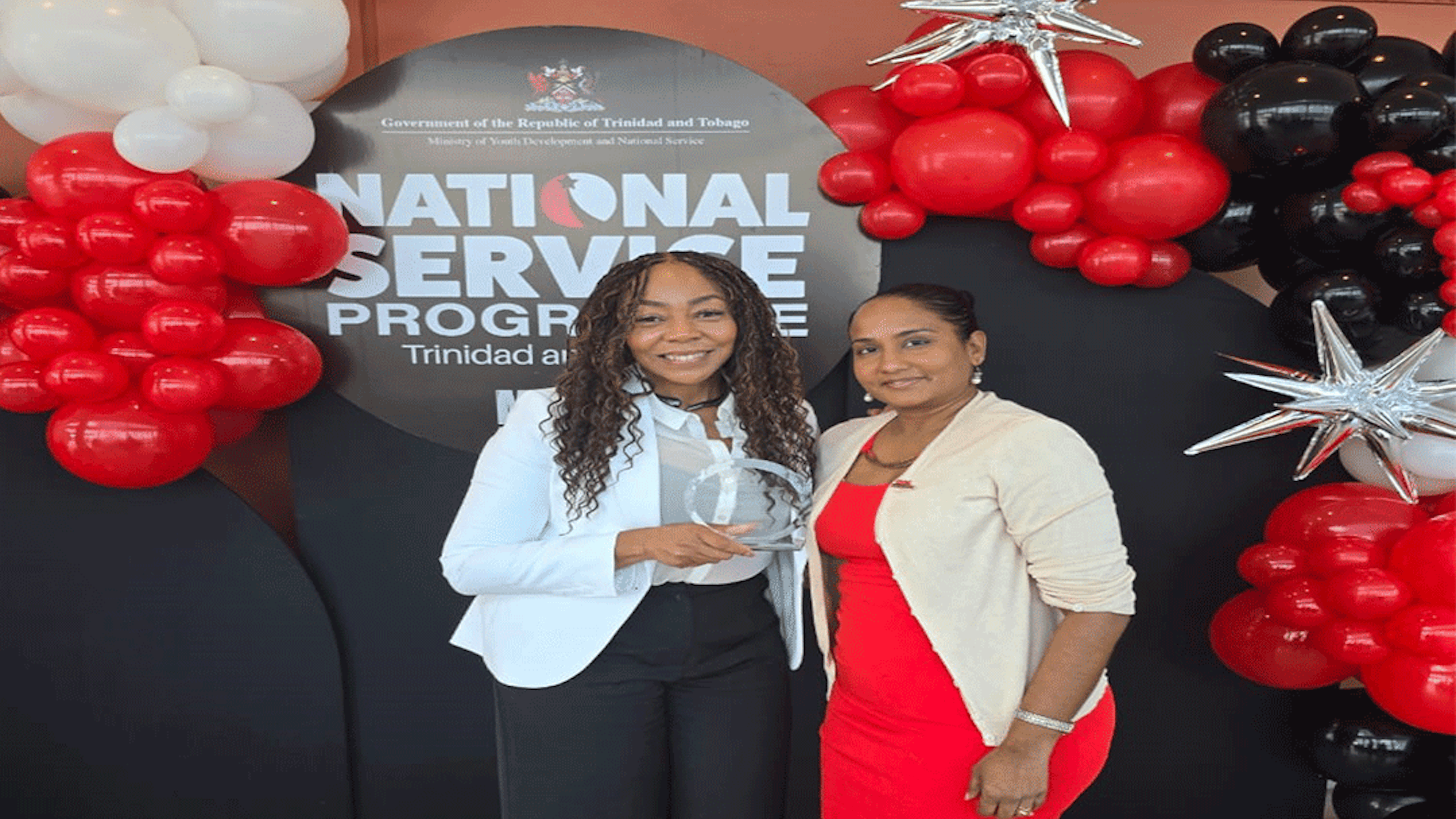 CEO Penny Gomez and Project Manager Diana Mathura Hobson holding award