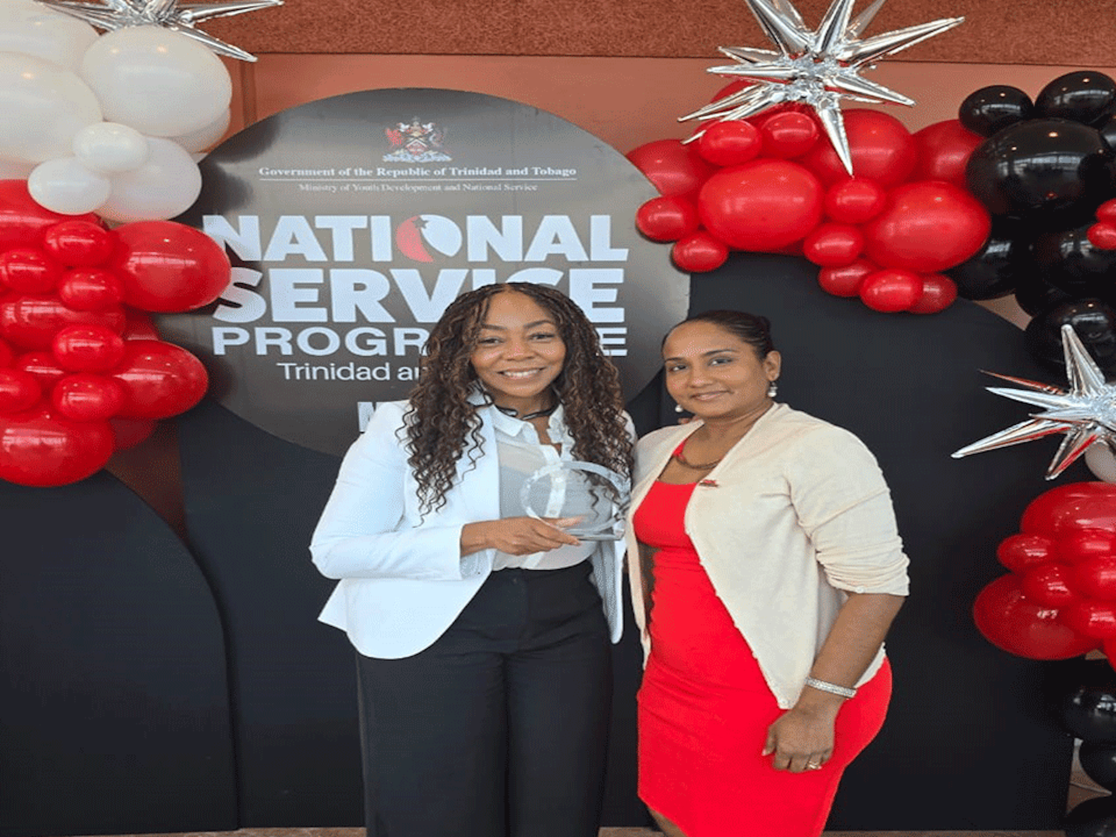 CEO Penny Gomez and Project Manager Diana Mathura Hobson holding award