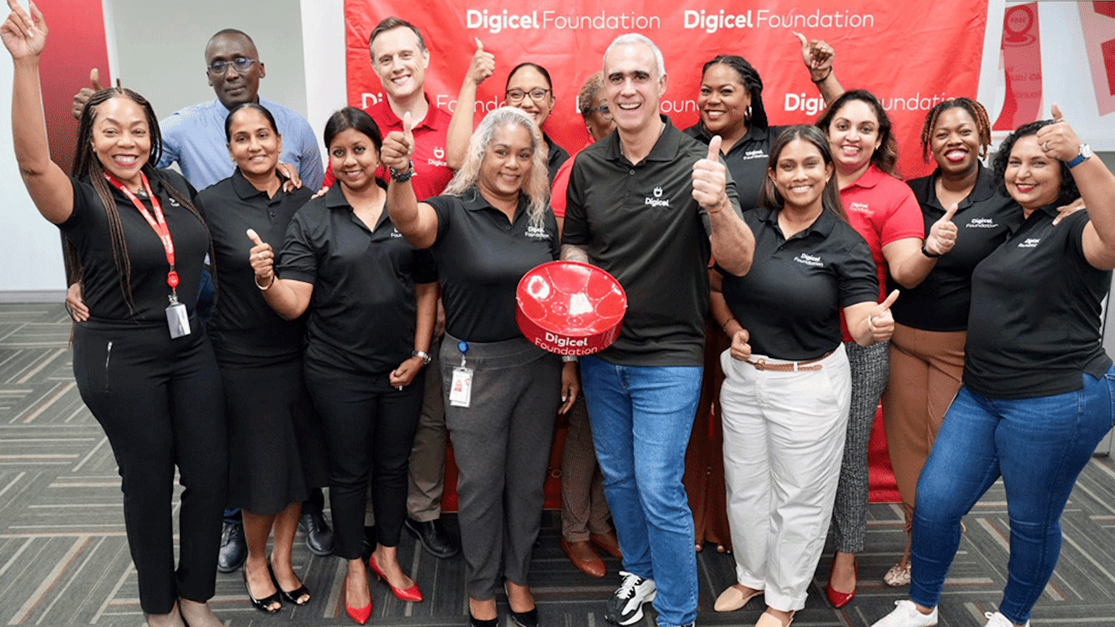 Group comprising foundation board and operational team go thumbs up with group CEO Marcello