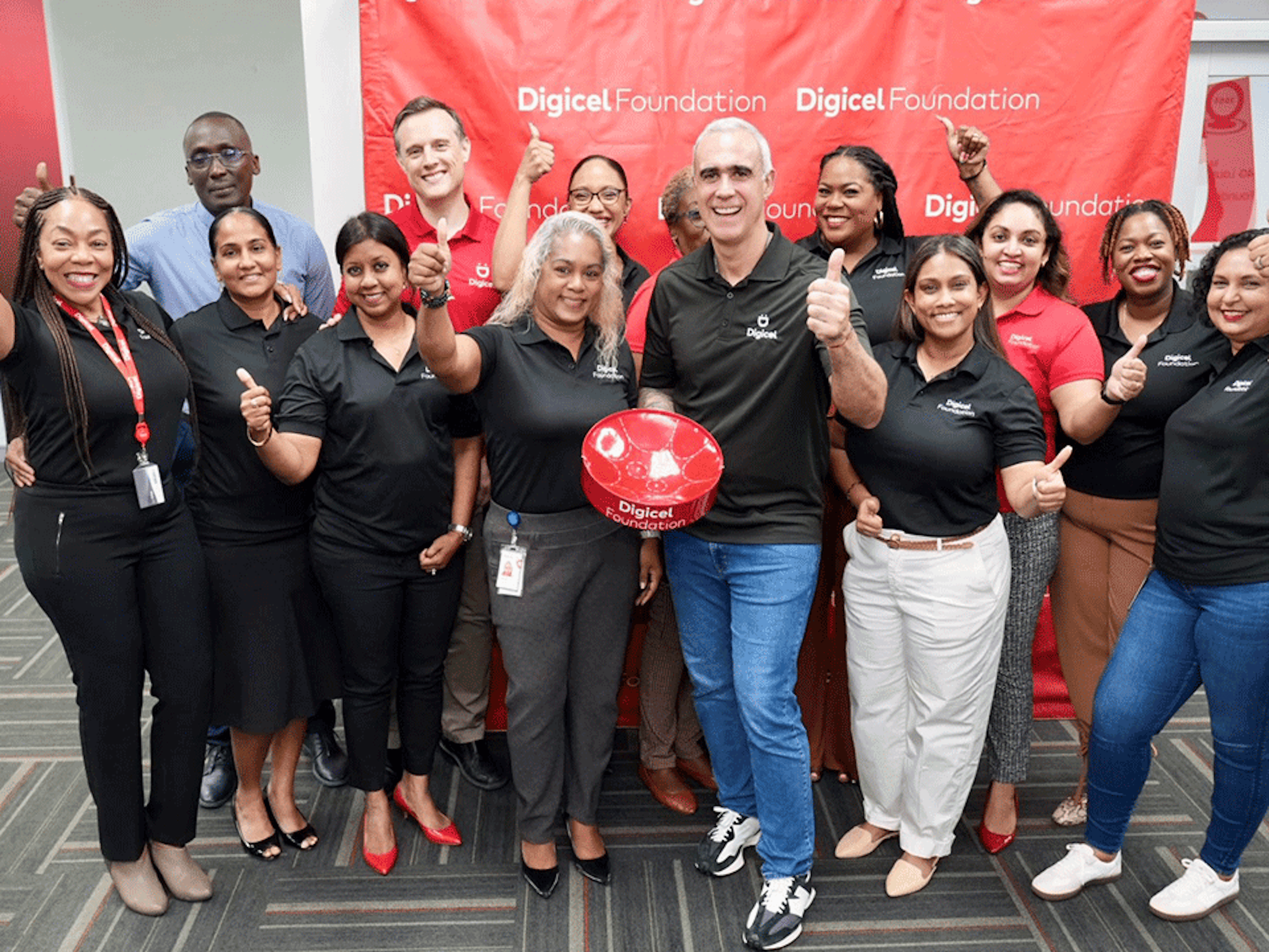 Group comprising foundation board and operational team go thumbs up with group CEO Marcello