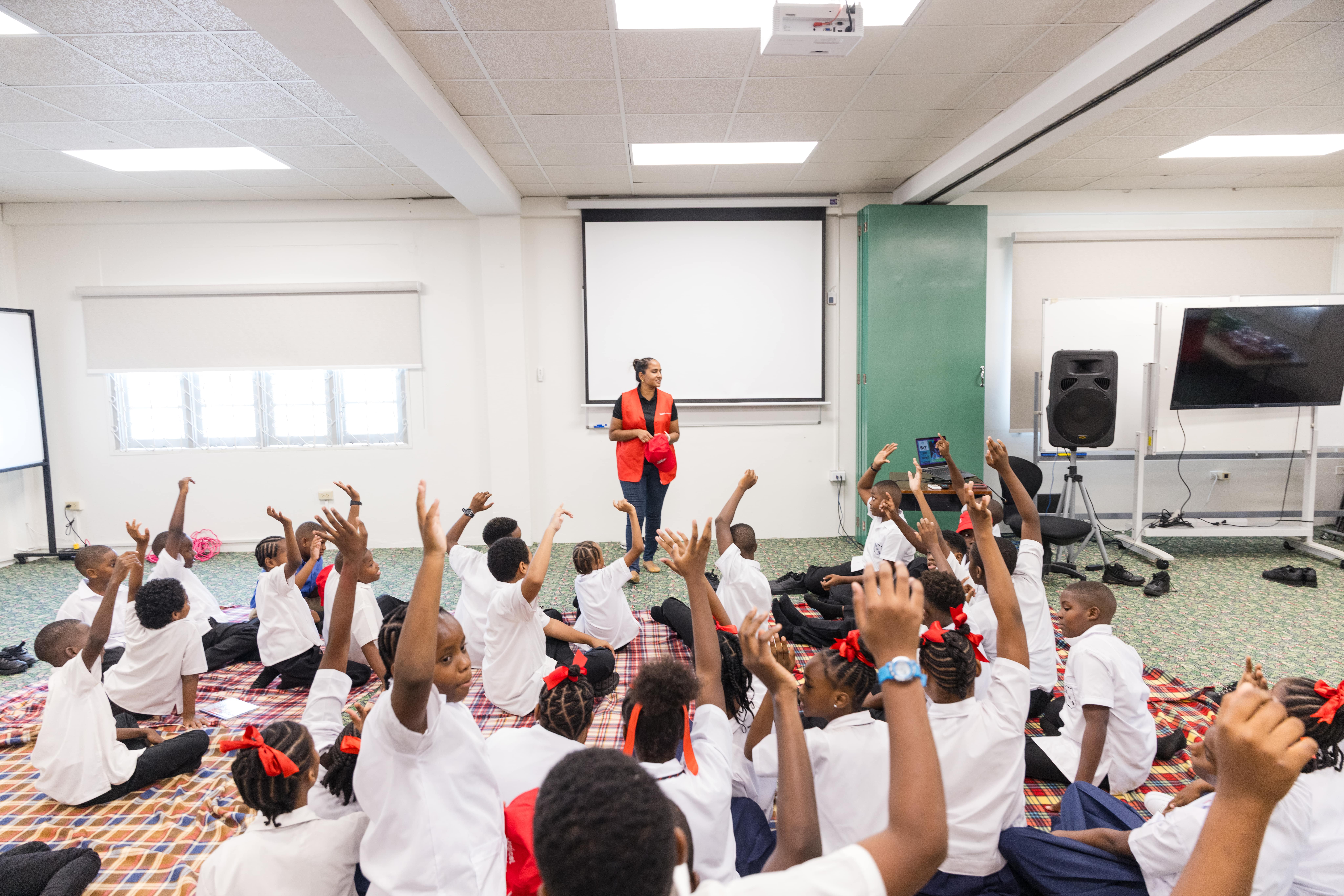 Digicel staff facilitating safer internet sessions with students