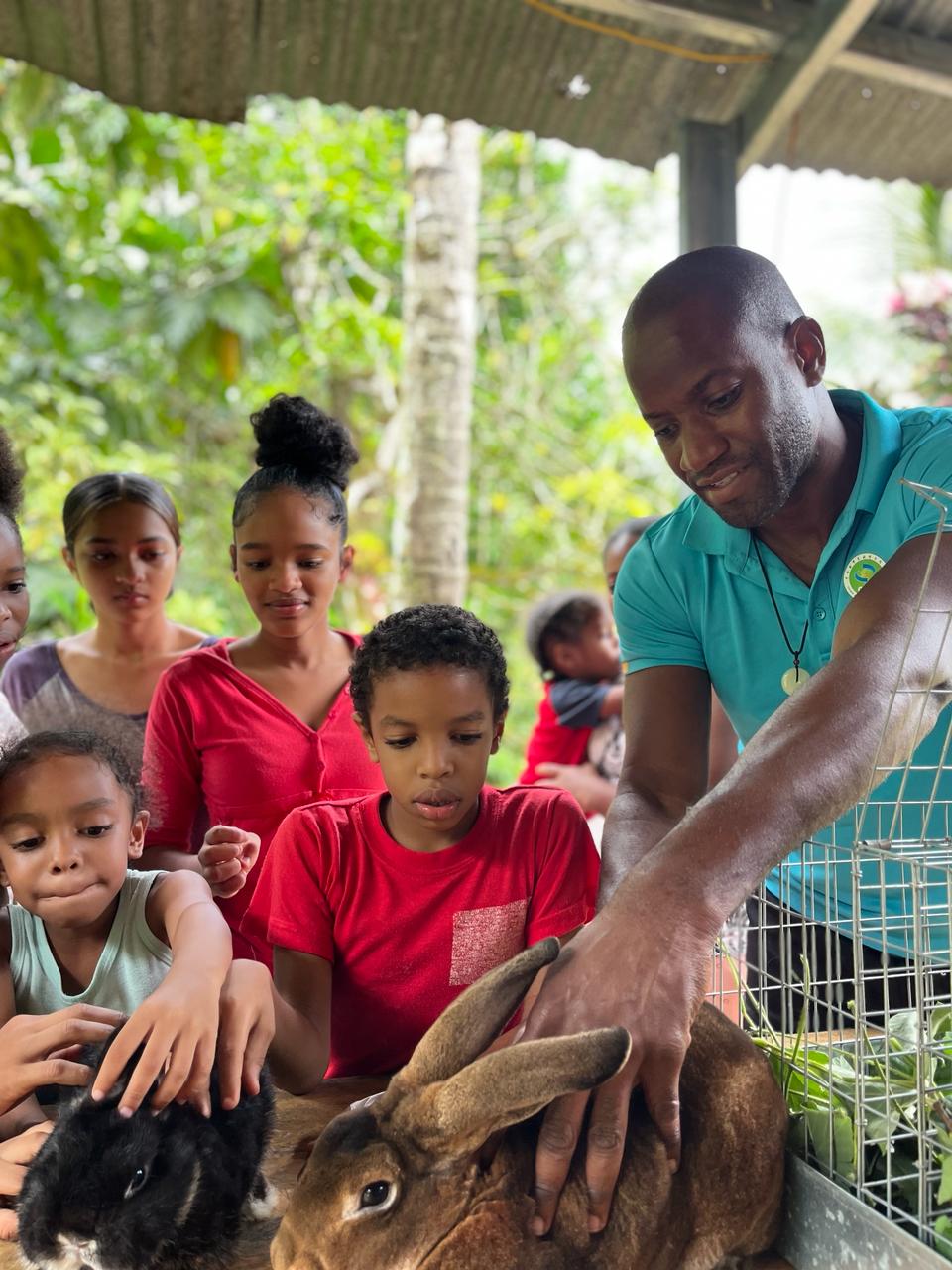 man and children with rabbits