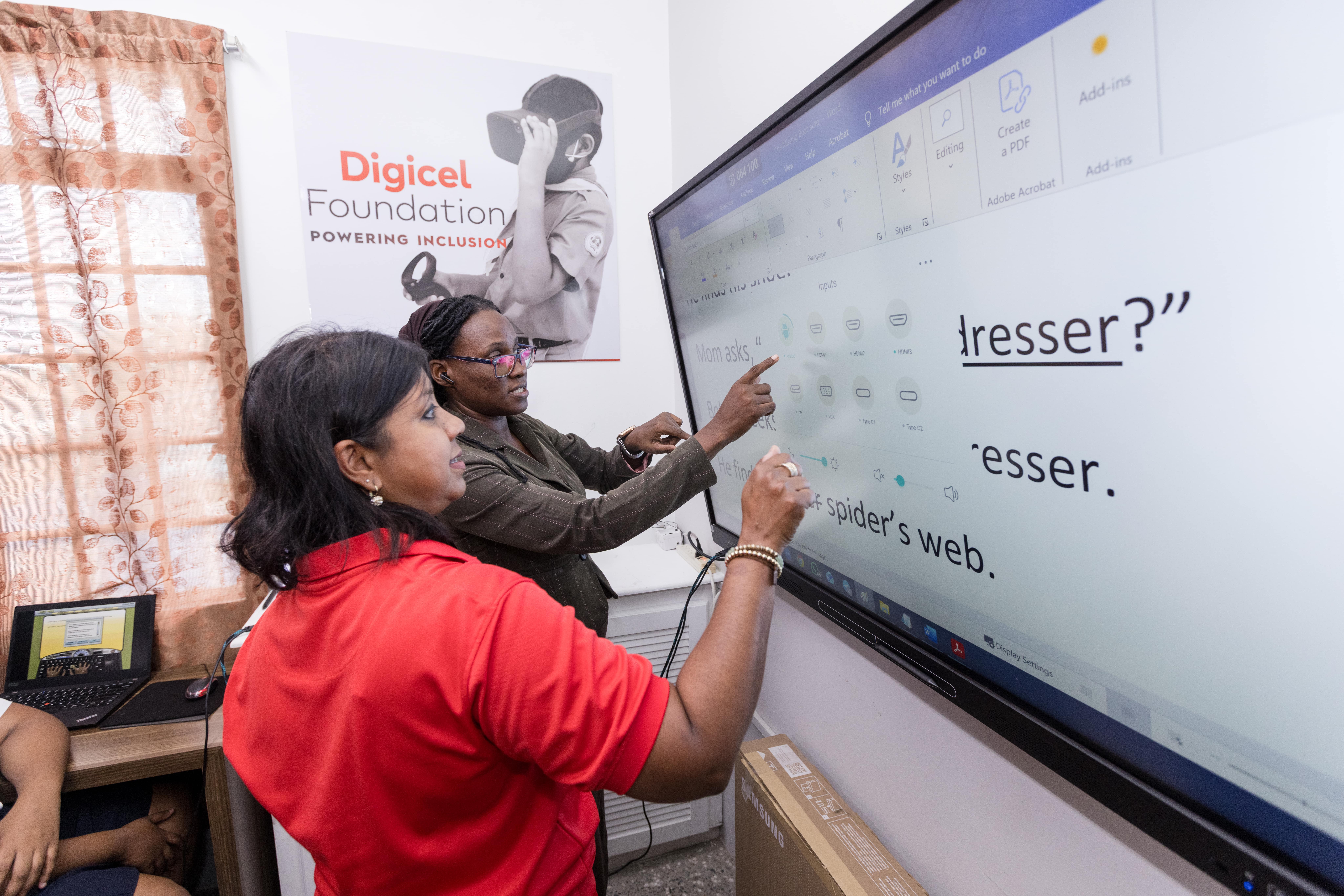 Two adults using a smart board