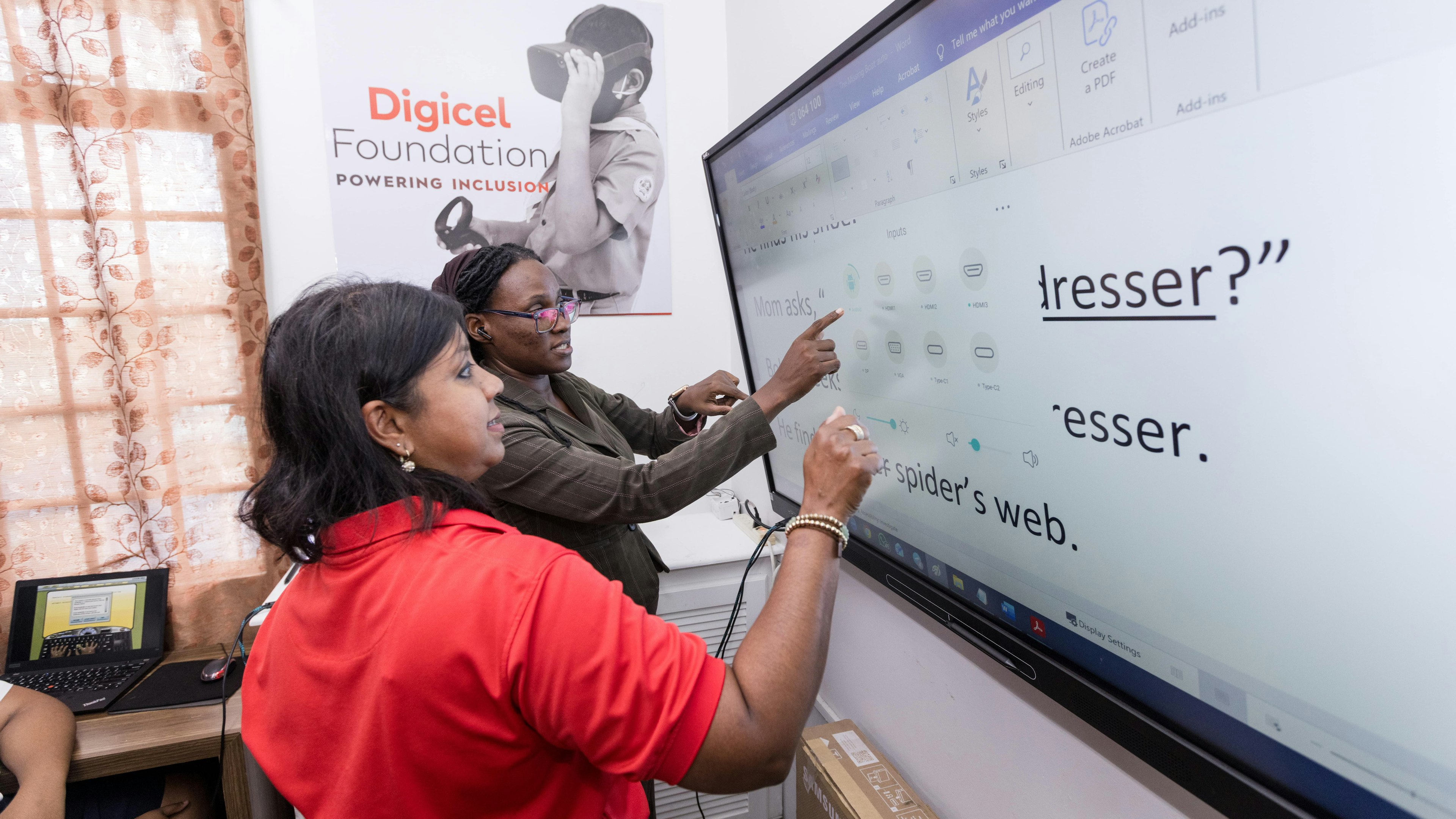 Two adults using a smart board