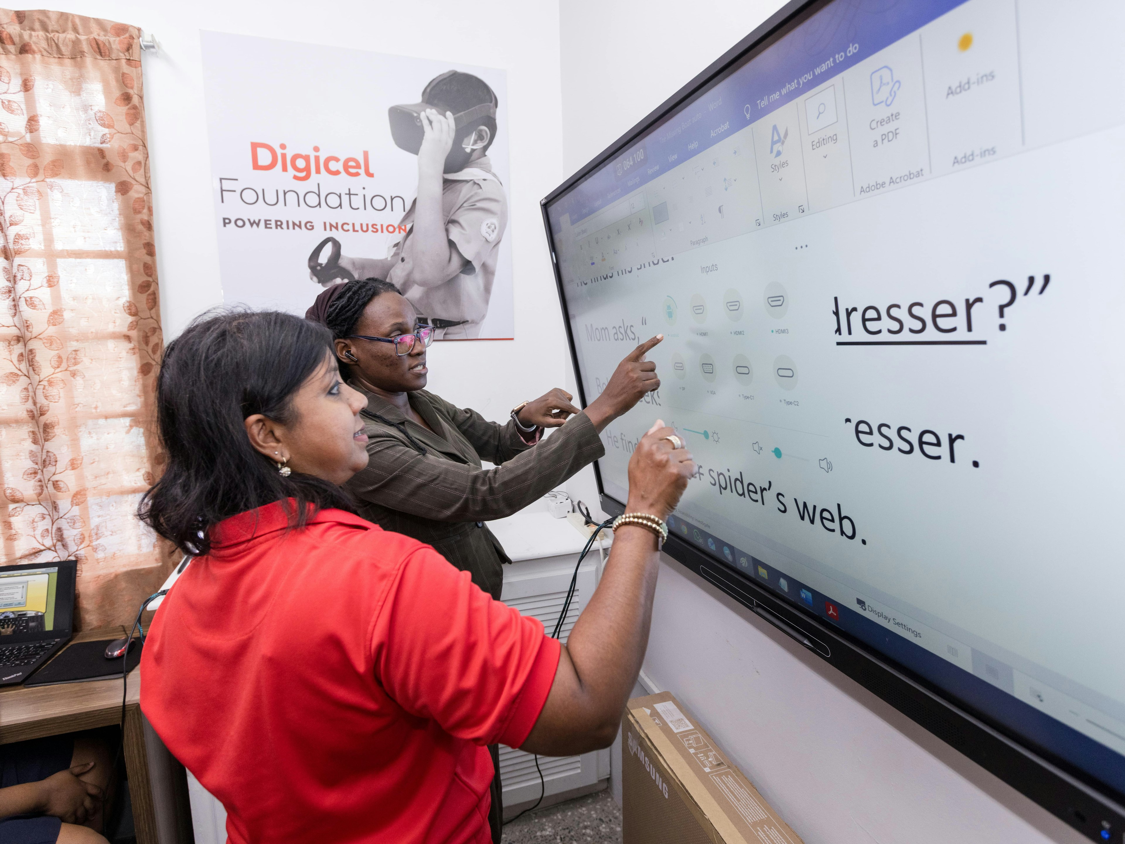 Two adults using a smart board