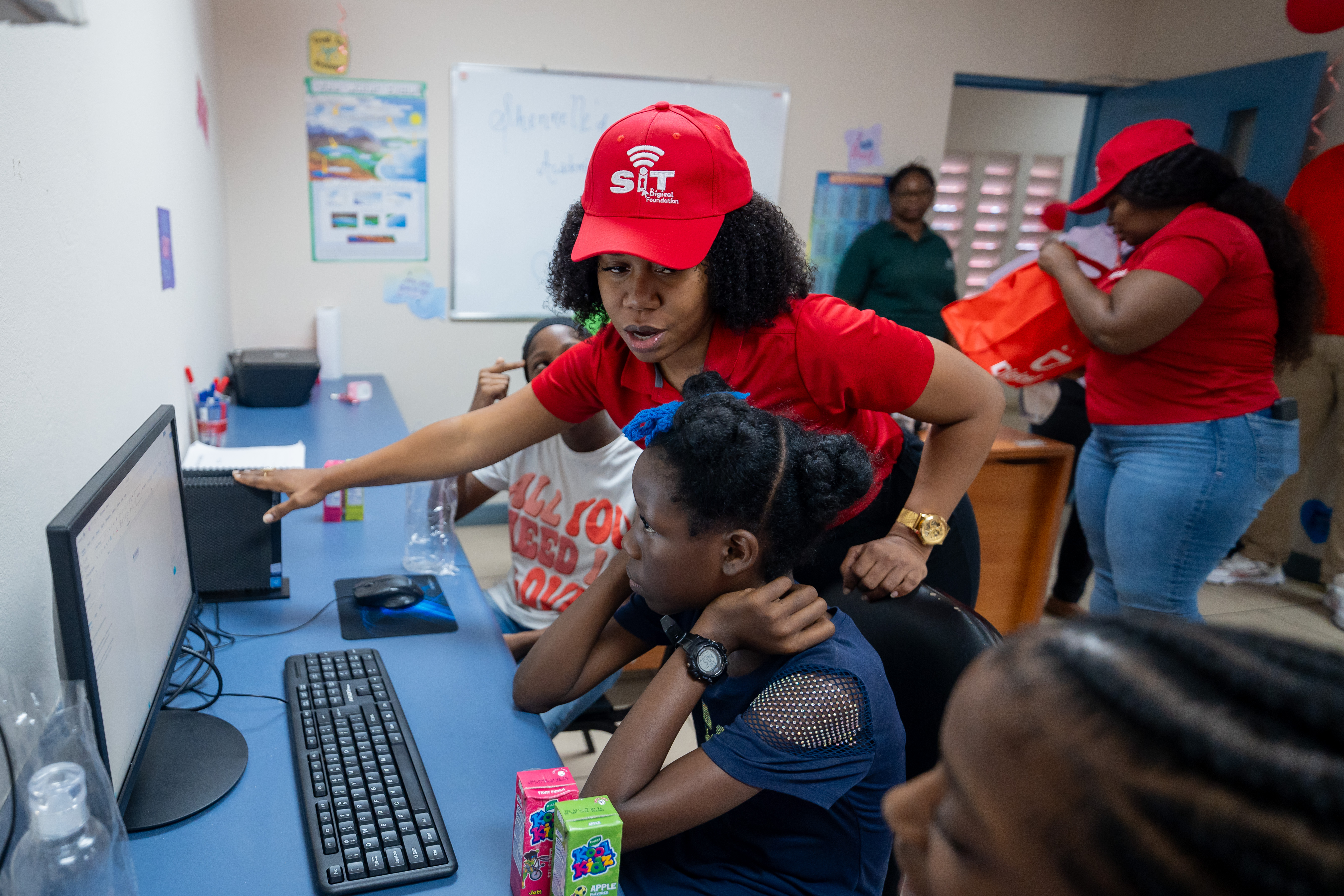 Digicel staff showing student a computer