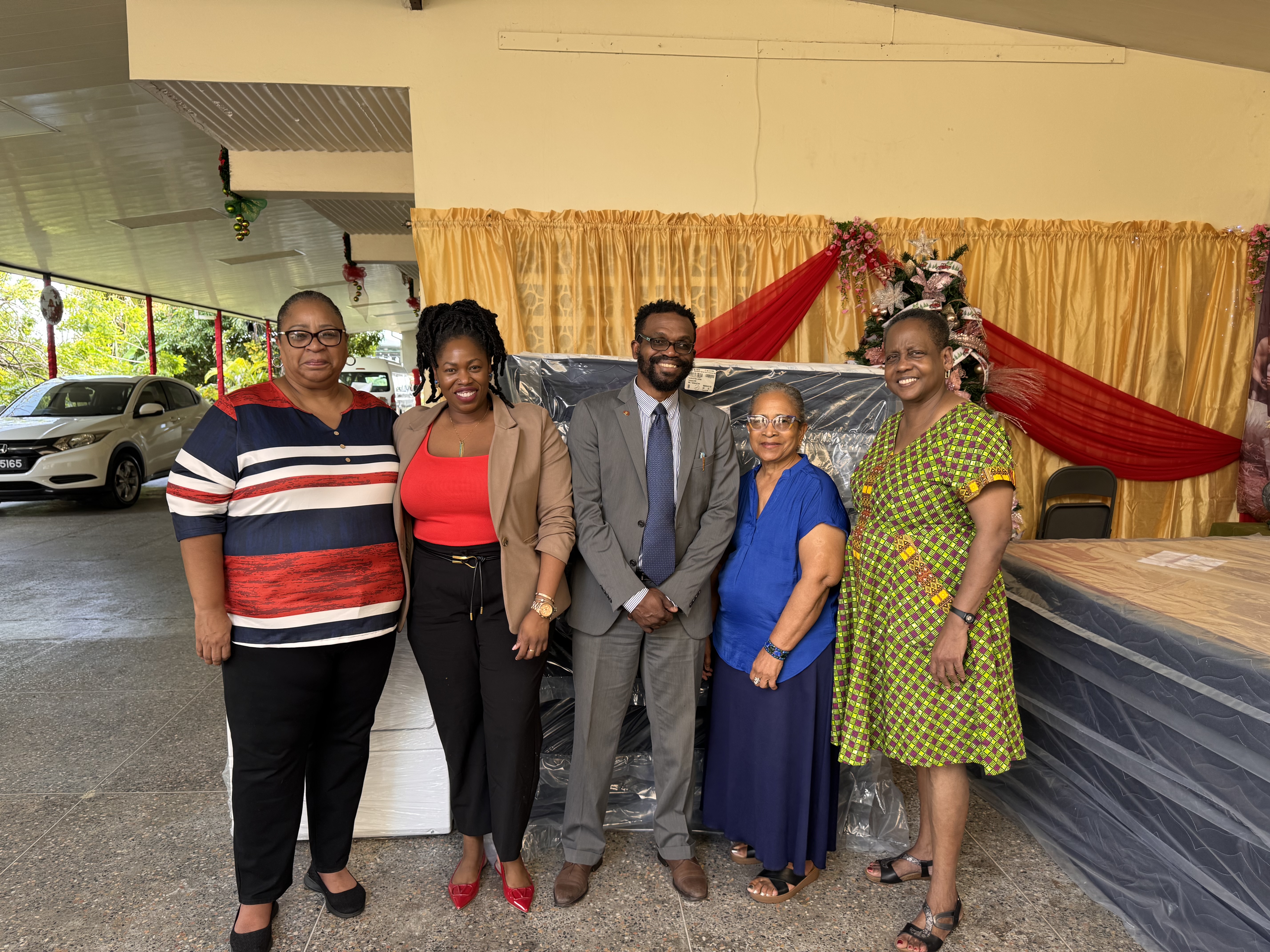 five persons posing for picture