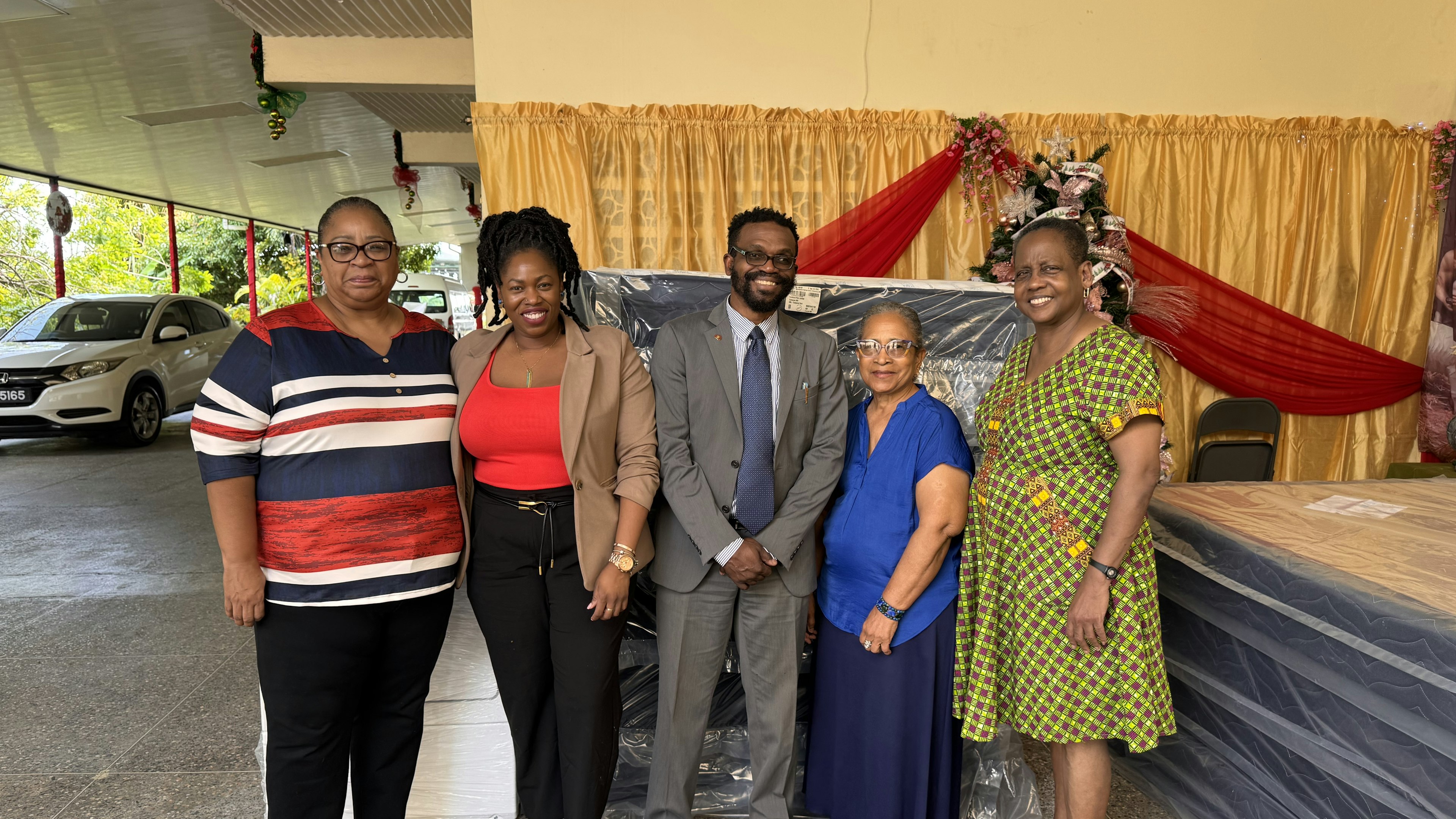 five persons posing for picture