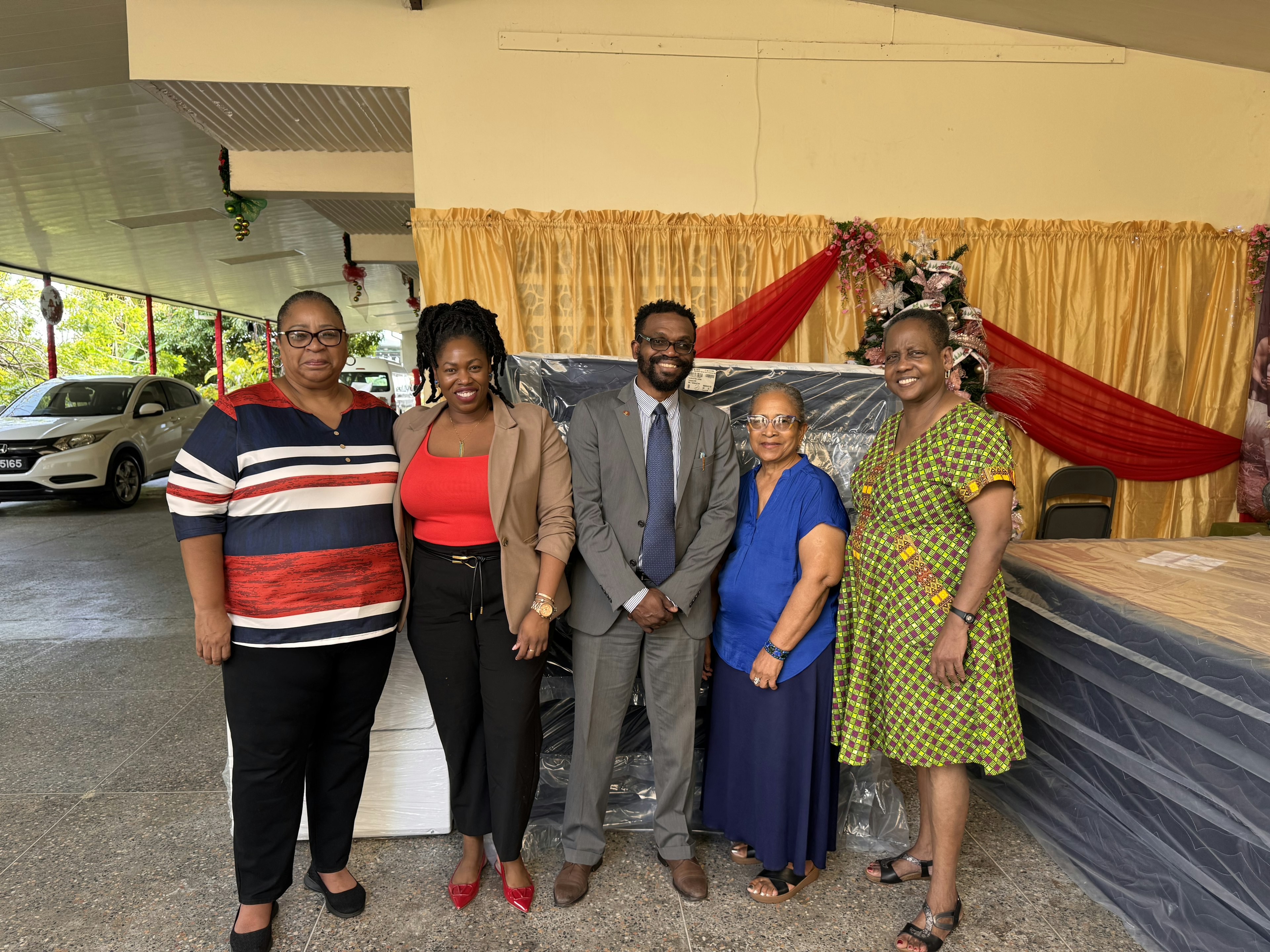 five persons posing for picture