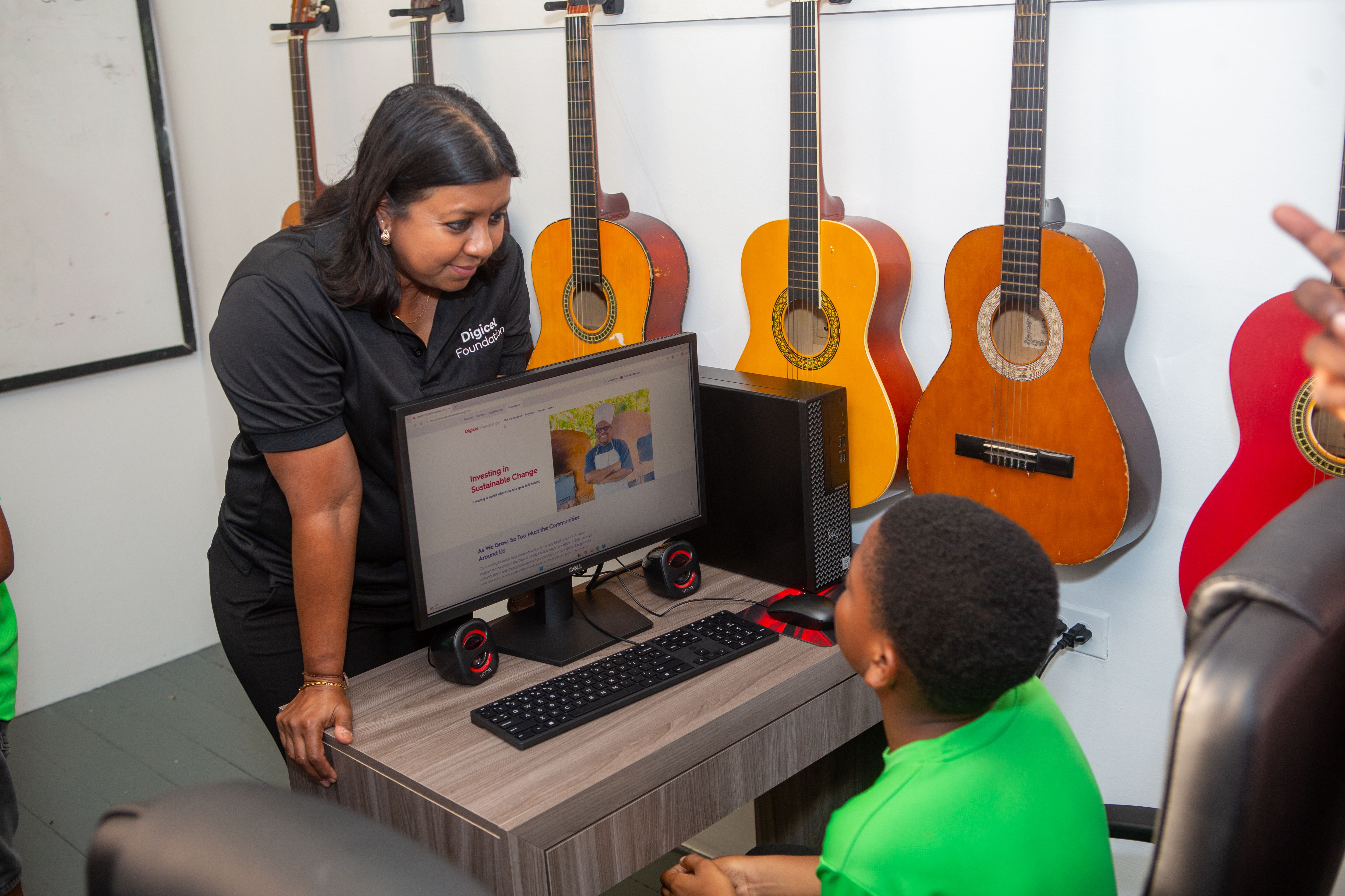 woman looking at child using a laptop