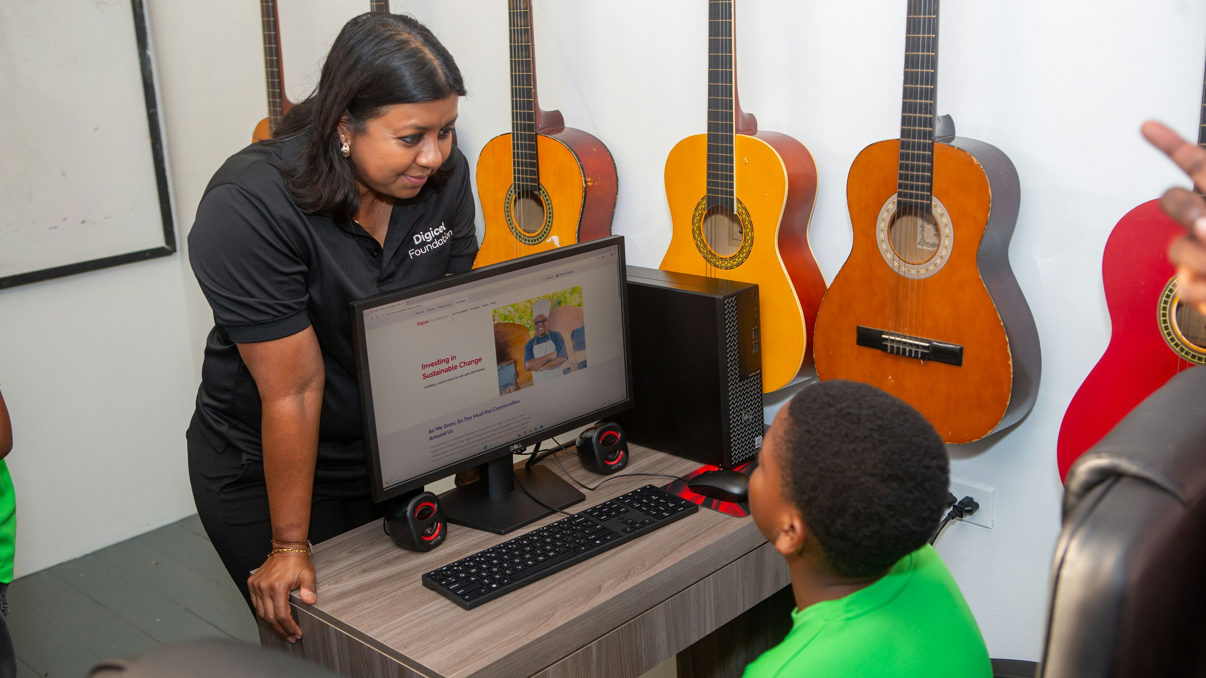 woman looking at child using a laptop