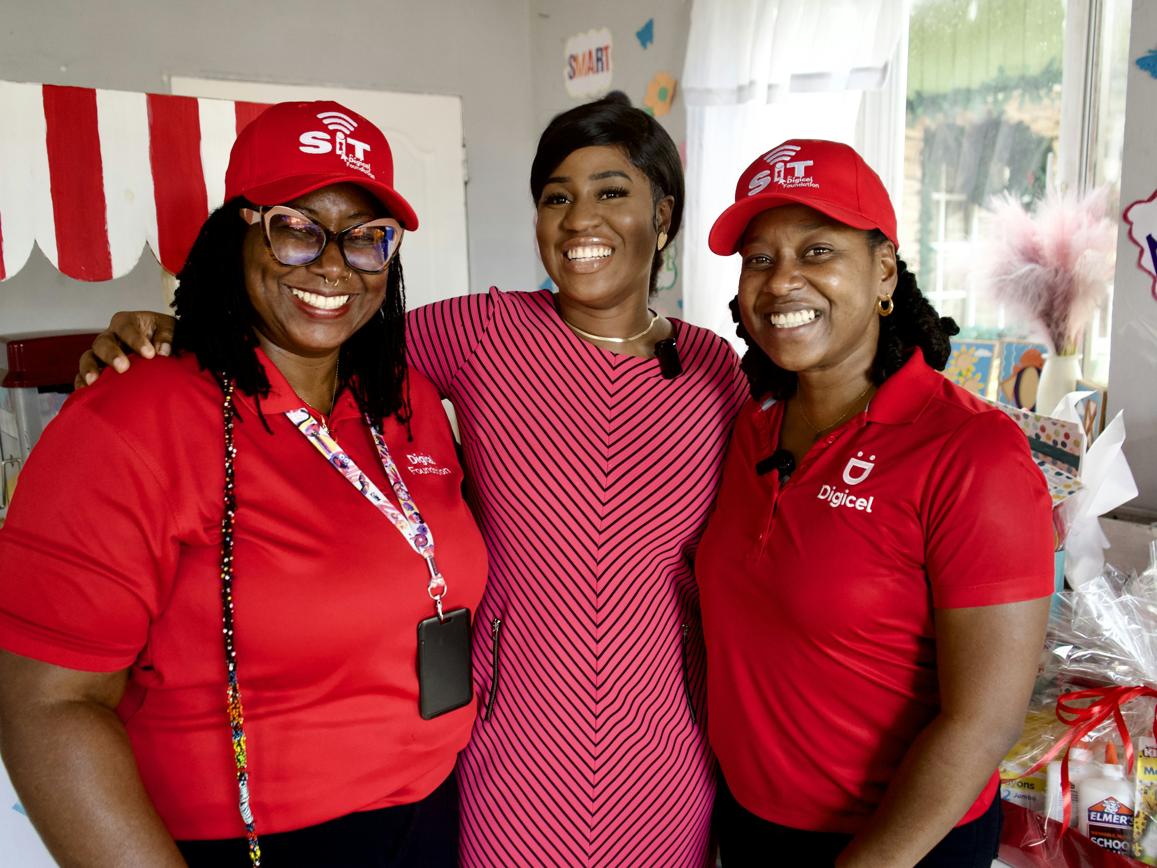 Digicel staff pose with pre school principal