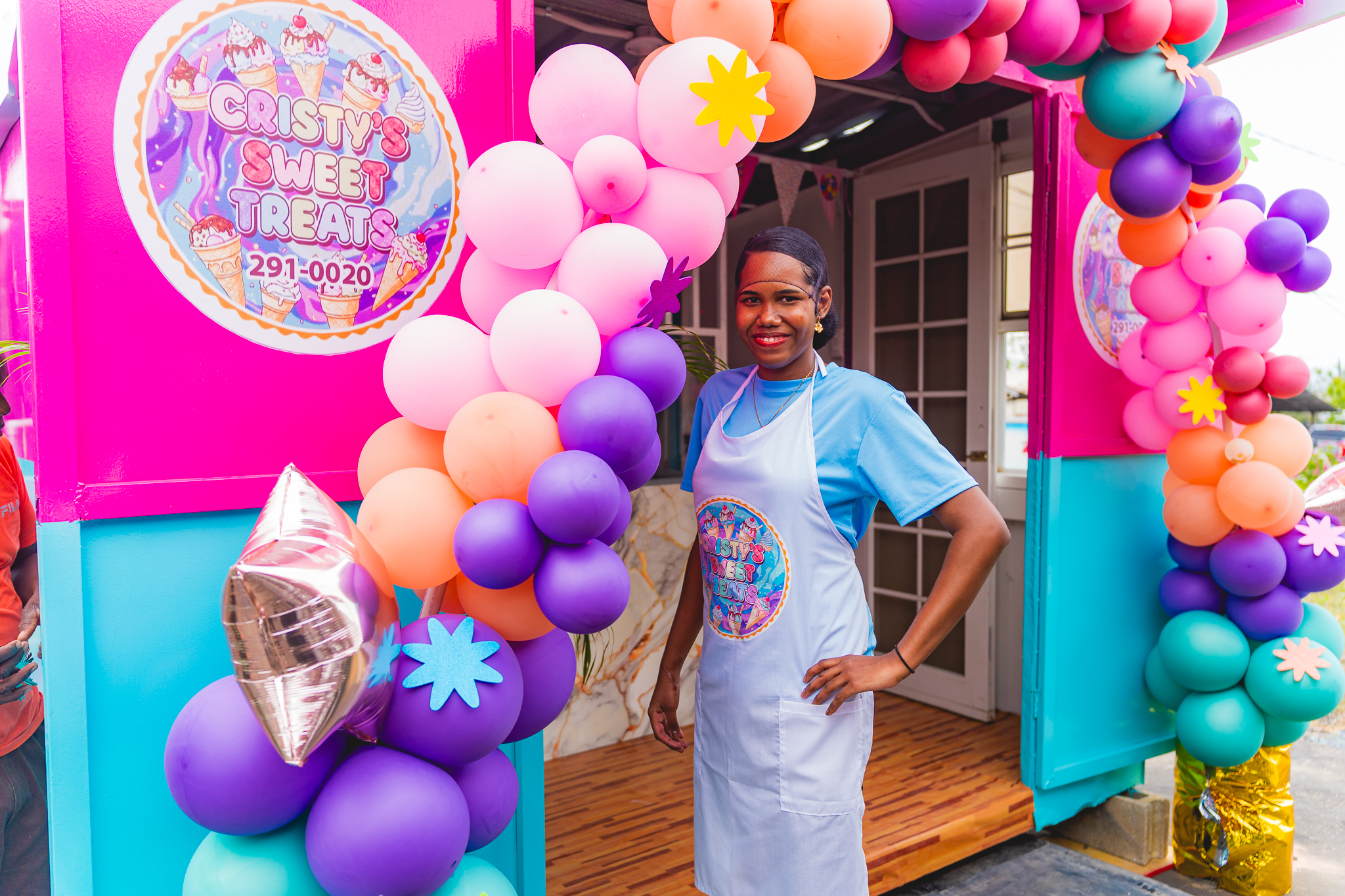 Cristy standing in front of her shop