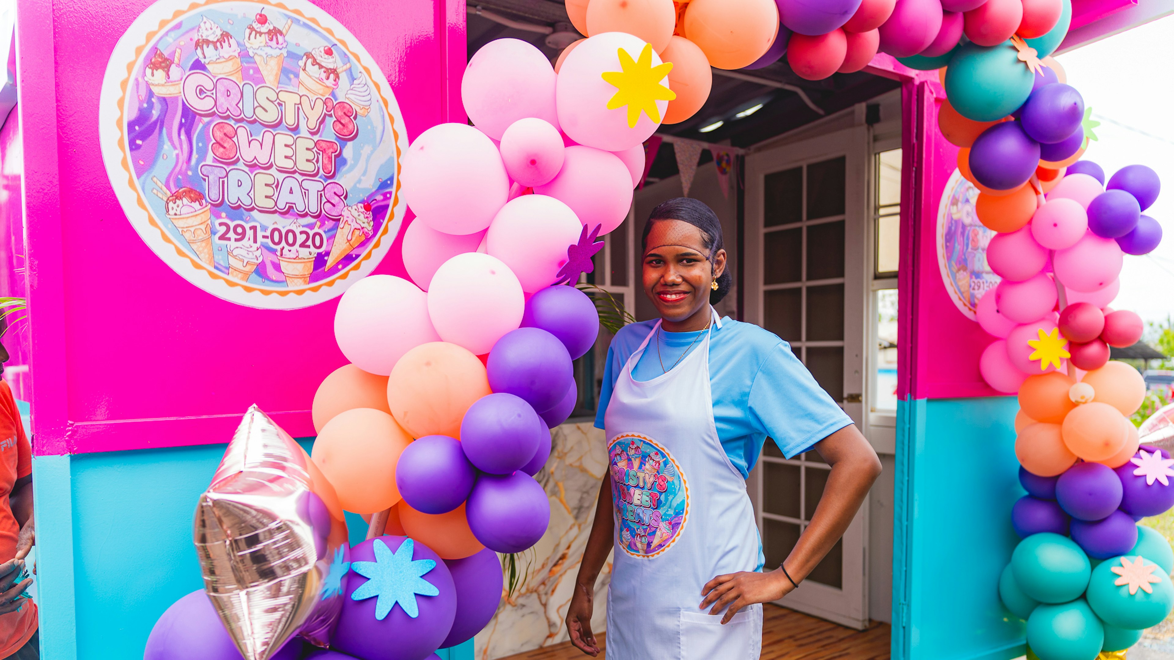 Cristy standing in front of her shop