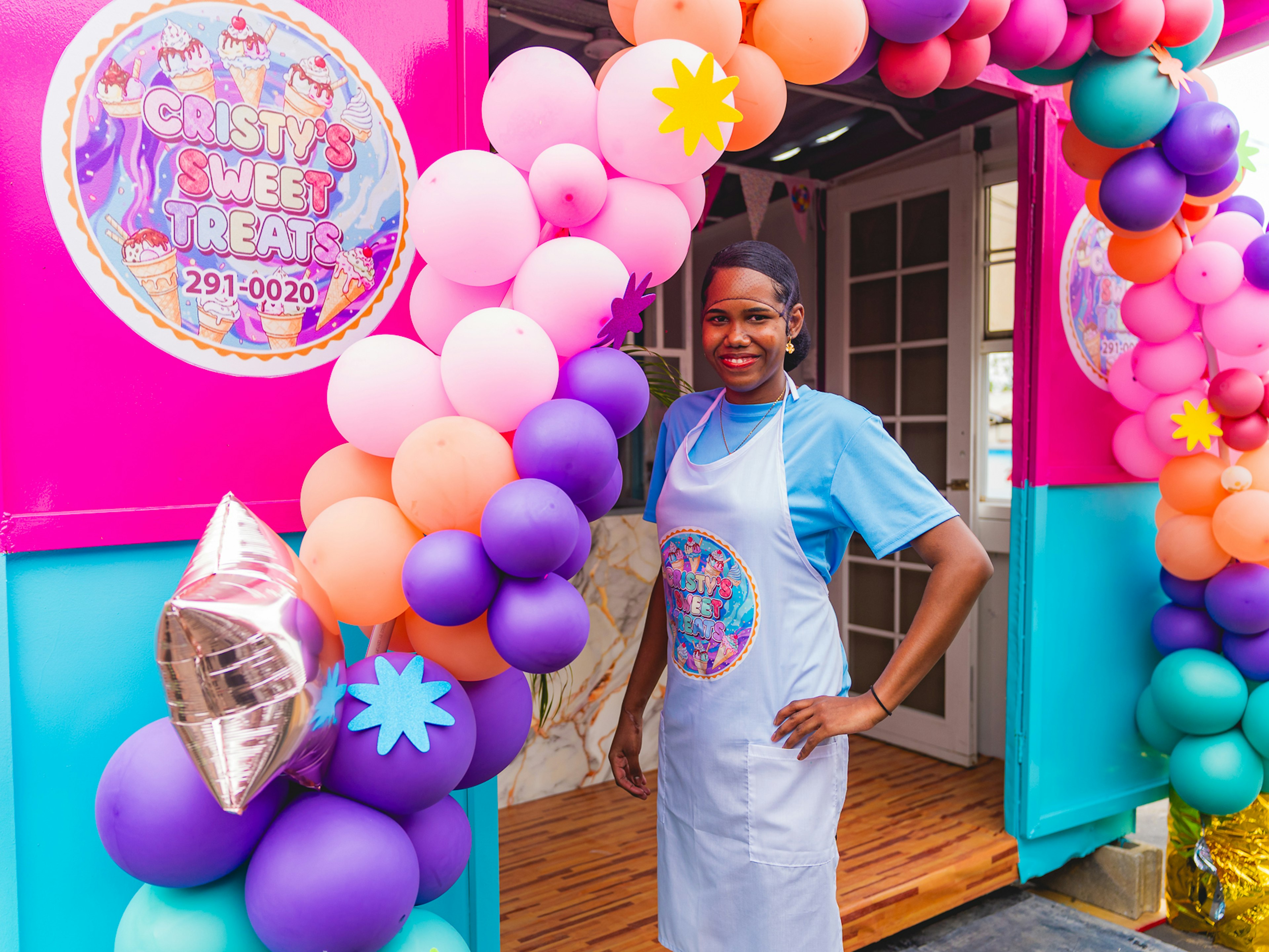 Cristy standing in front of her shop