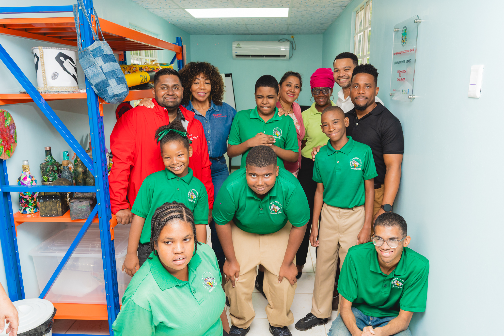 students pose for a picture with Digicel staff