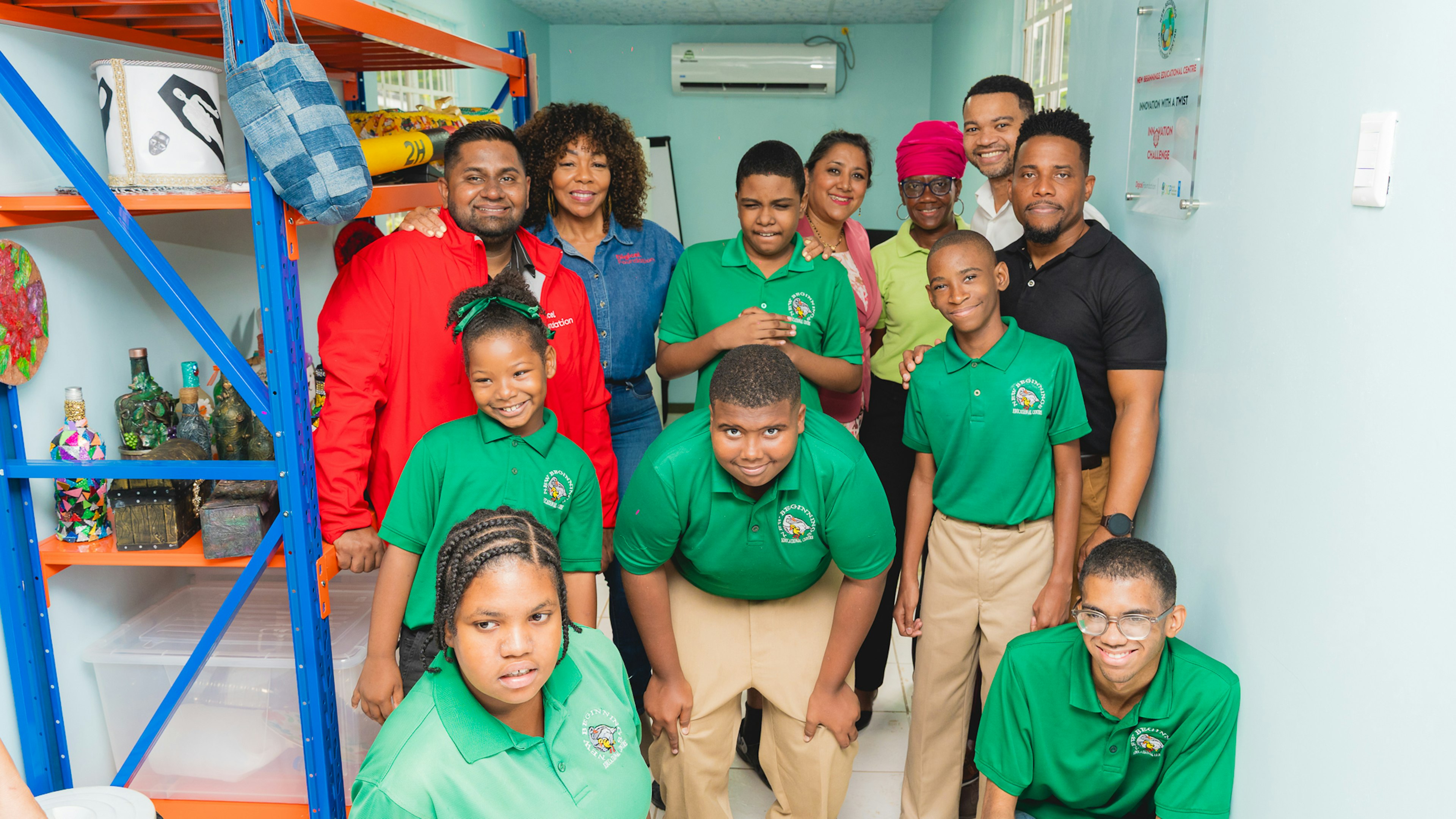 students pose for a picture with Digicel staff
