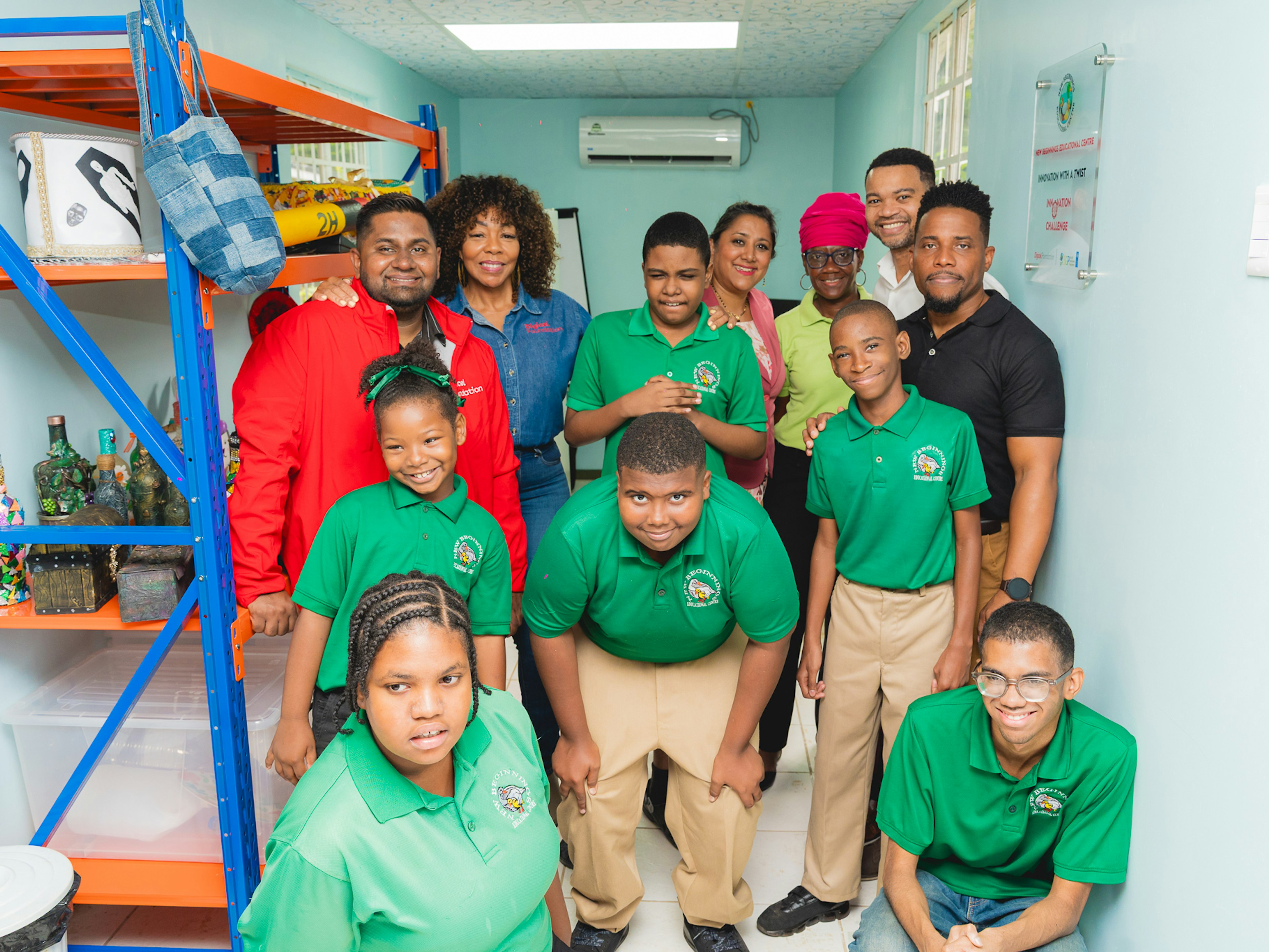students pose for a picture with Digicel staff