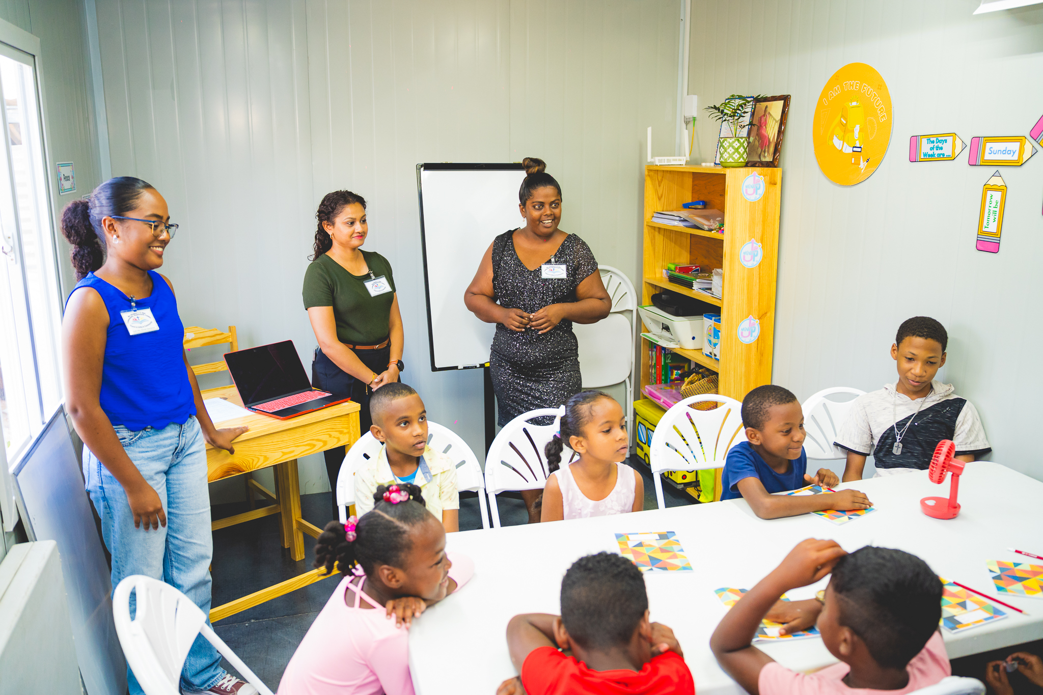volunteer teachers with students in new centre
