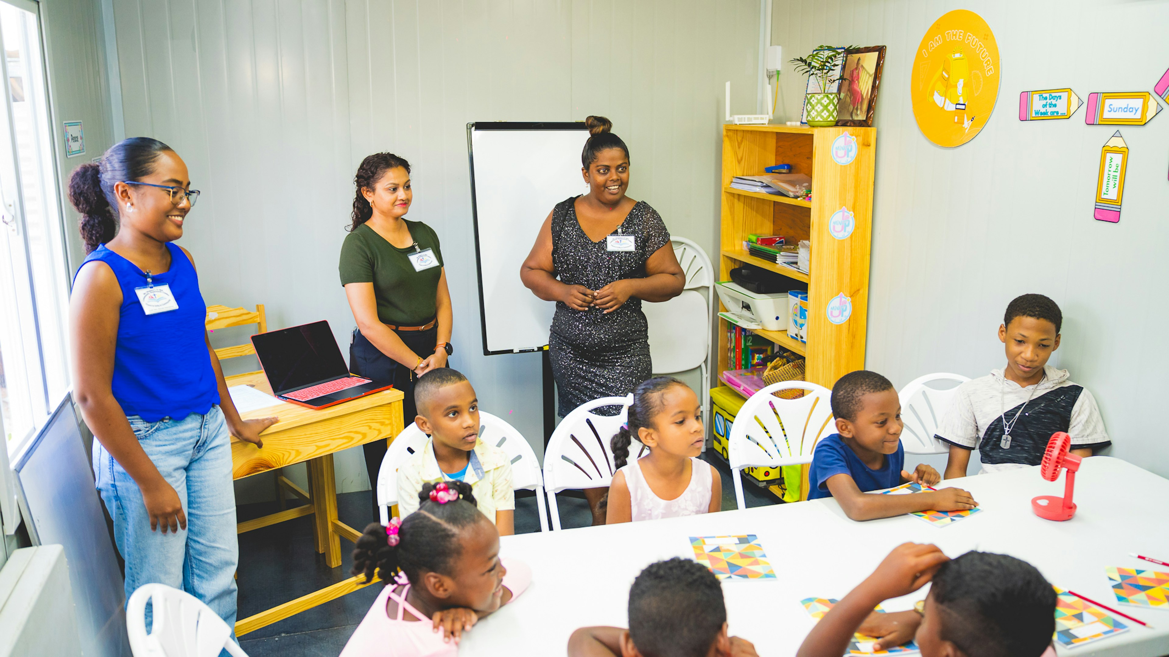 volunteer teachers with students in new centre
