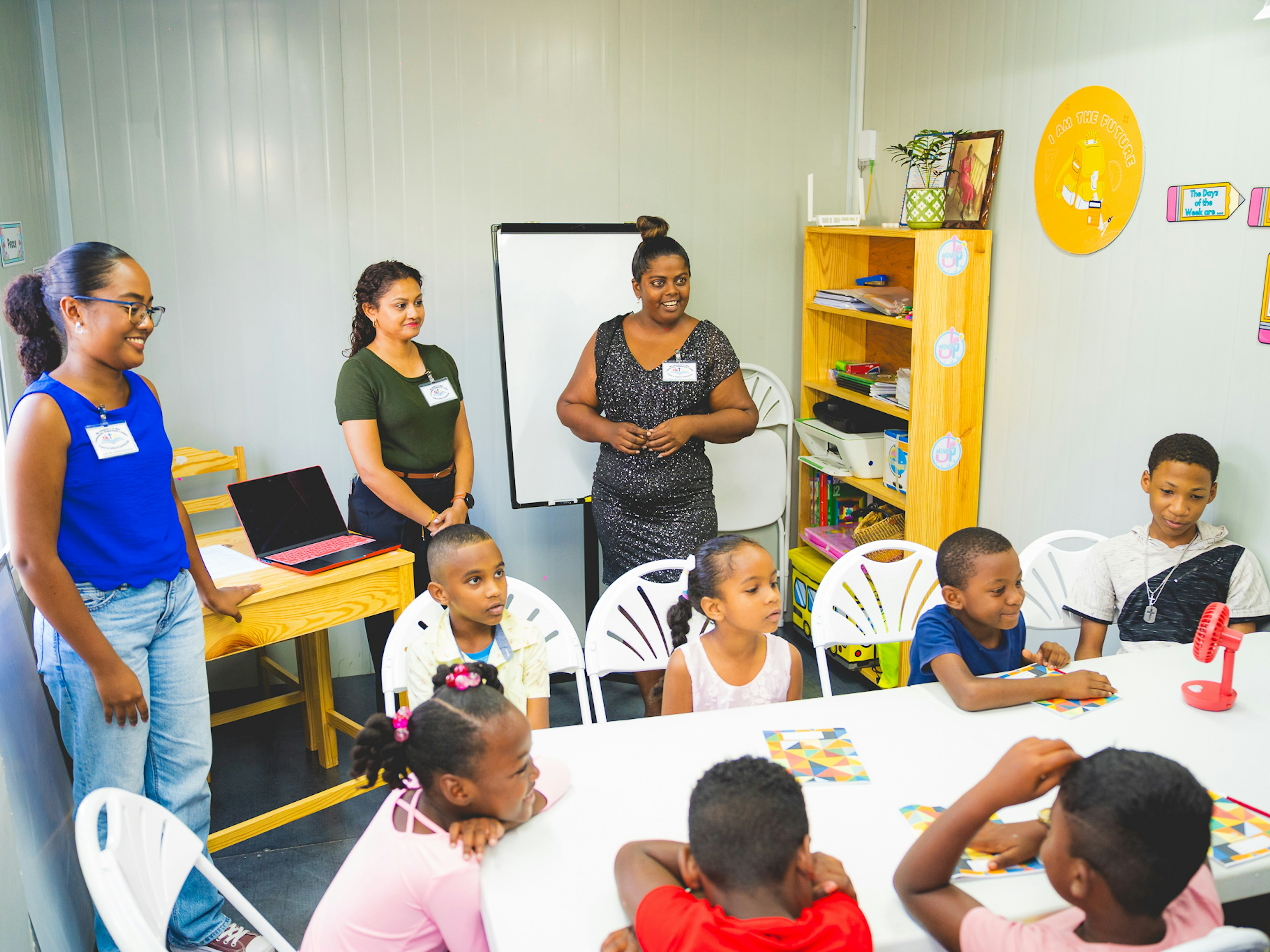 volunteer teachers with students in new centre