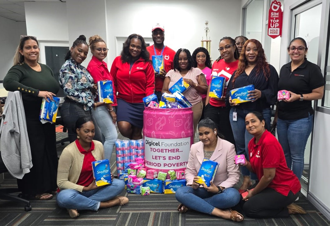 digicel staff pose around menstural hygiene donations