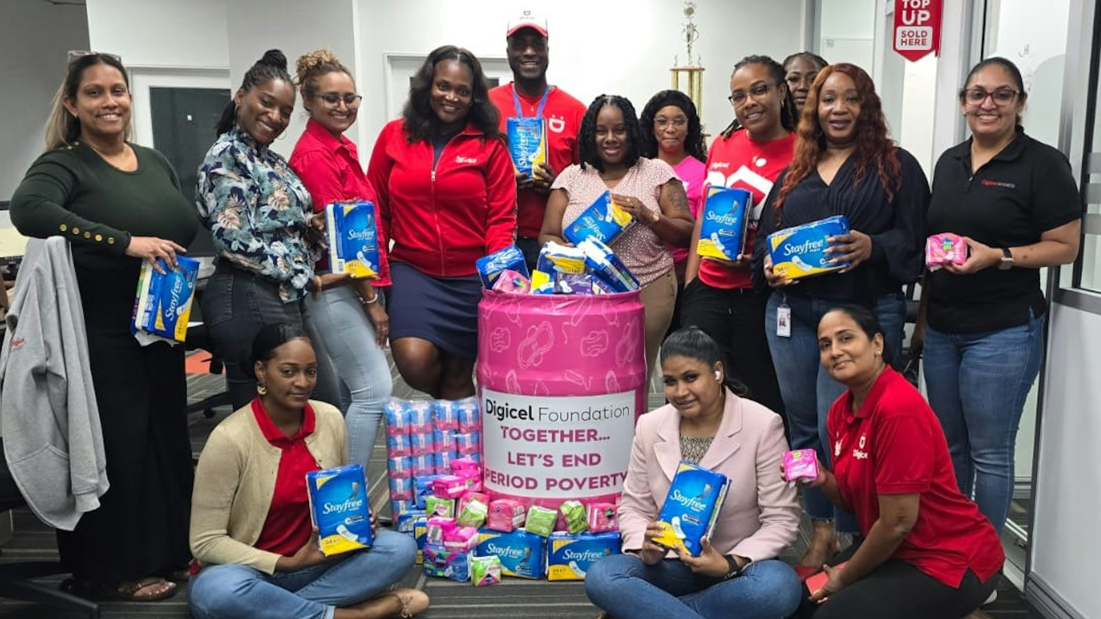 digicel staff pose around menstural hygiene donations
