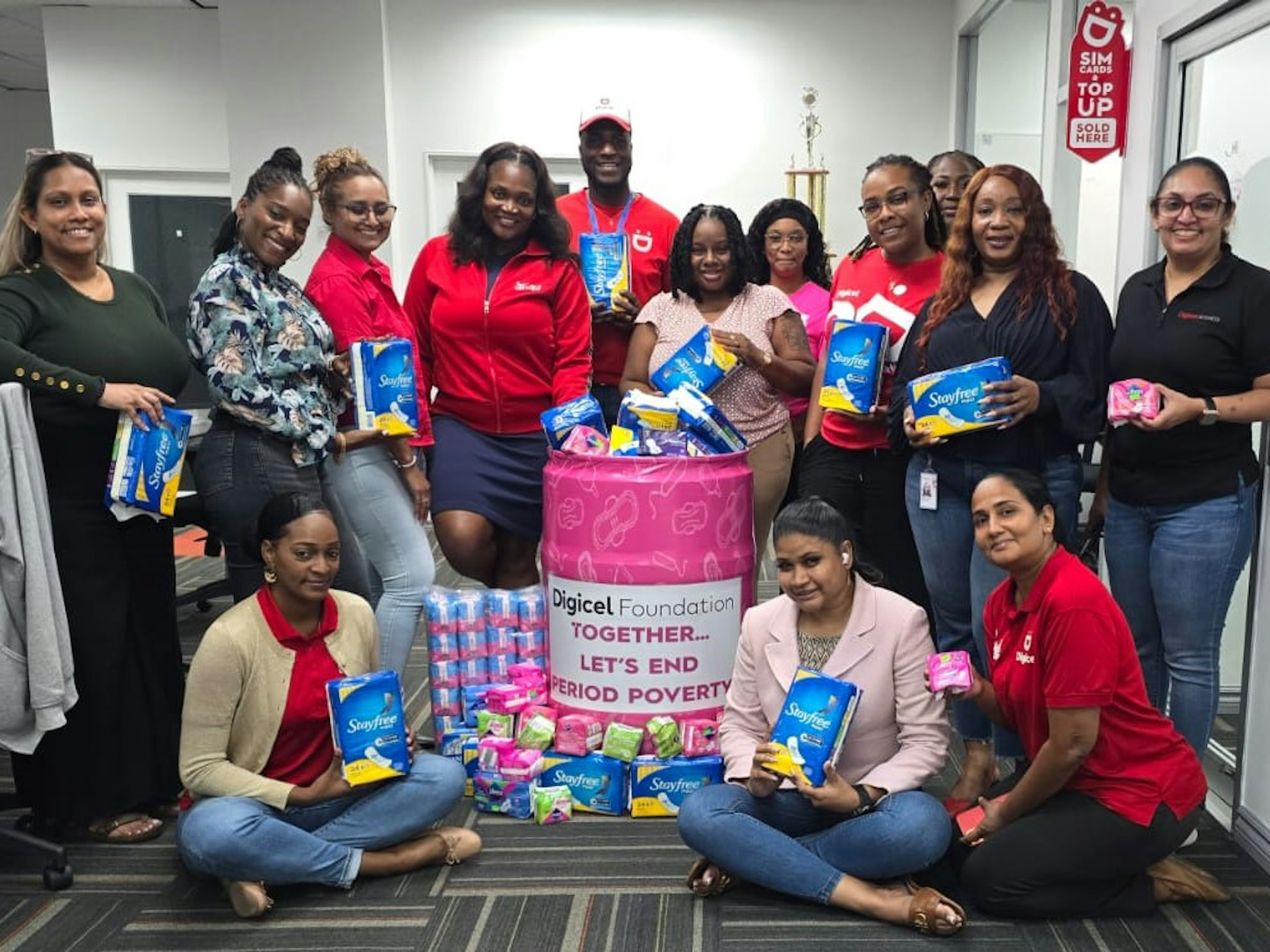 digicel staff pose around menstural hygiene donations