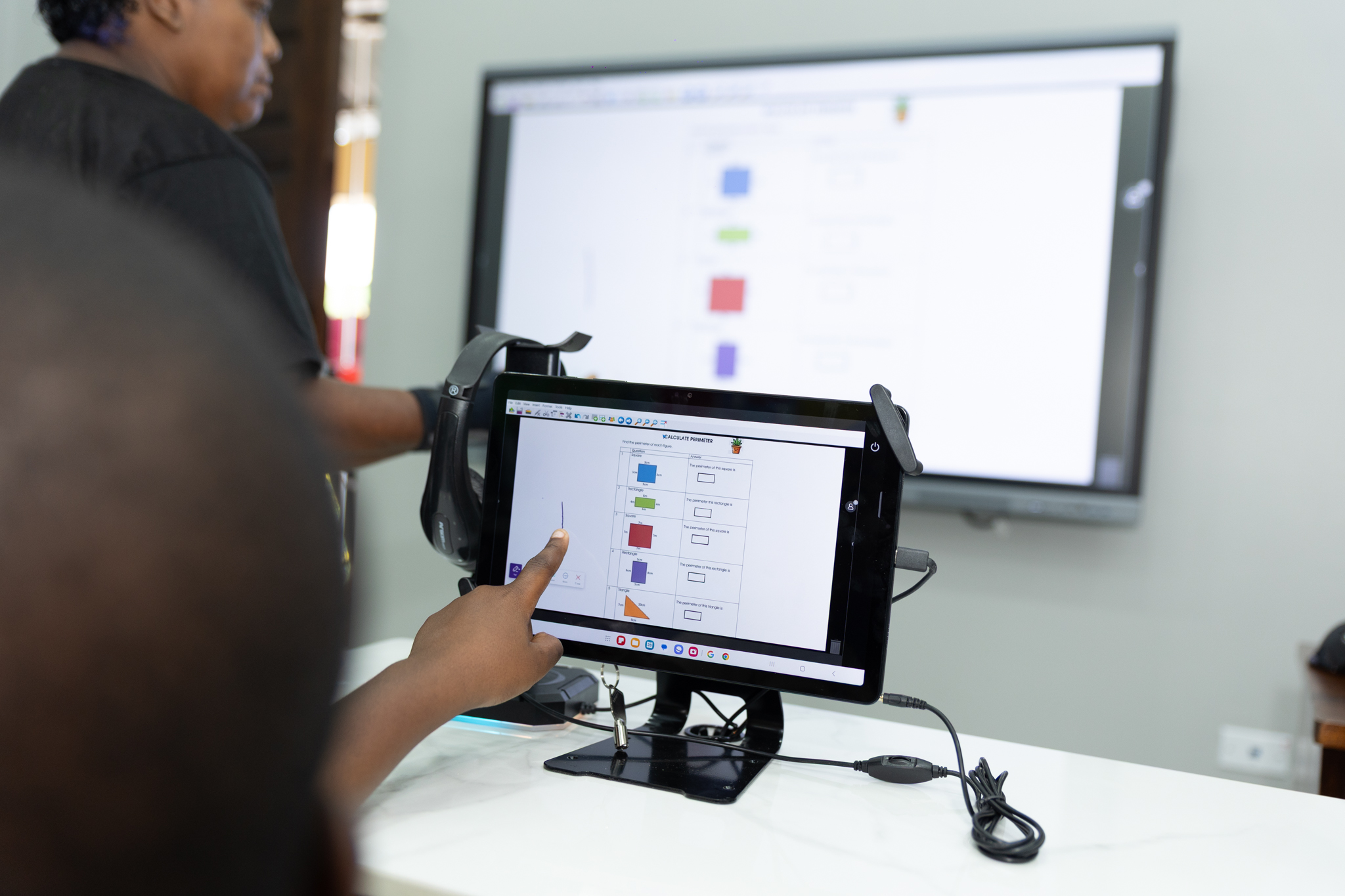 pointing at tablet screen