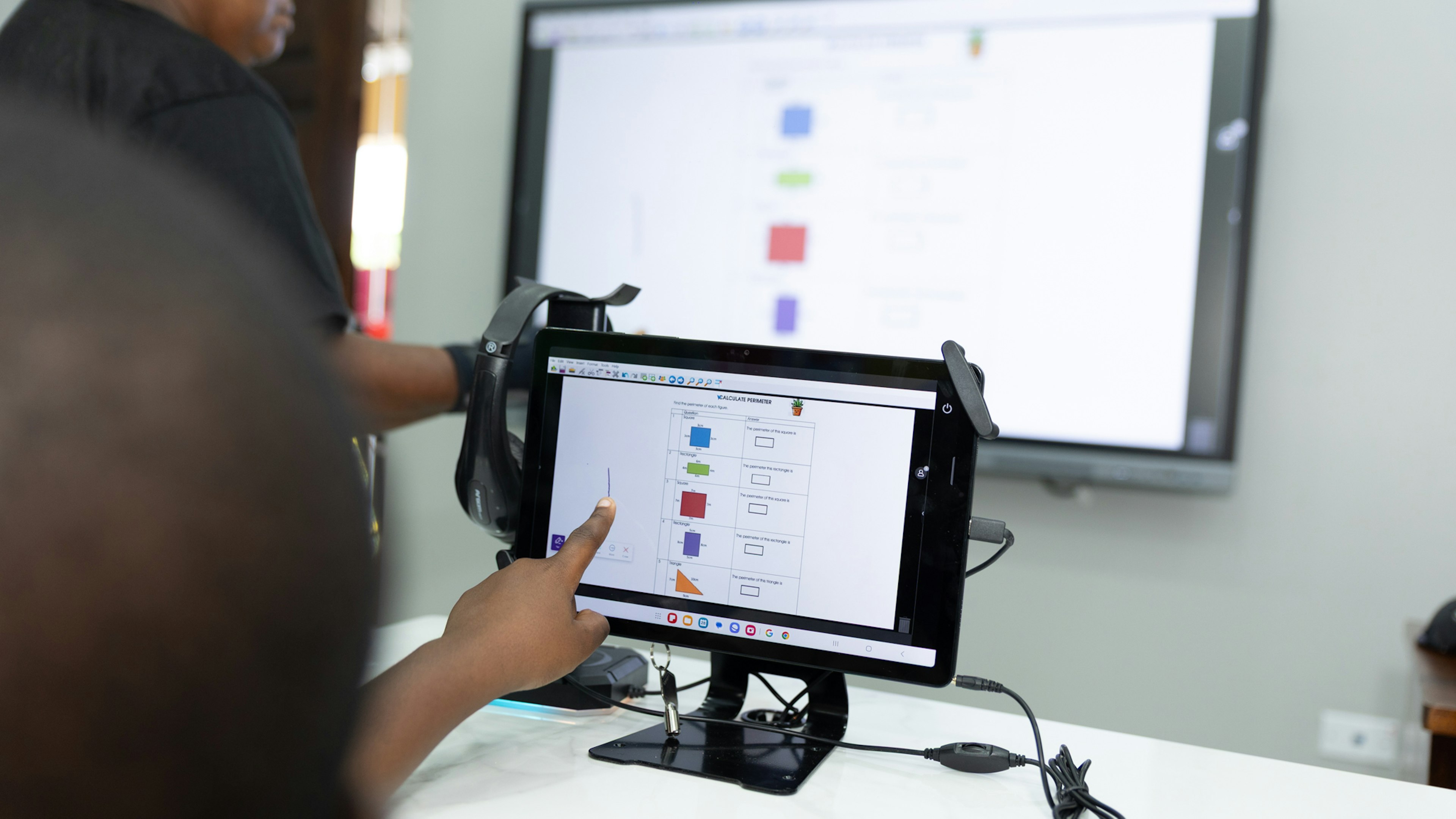 pointing at tablet screen