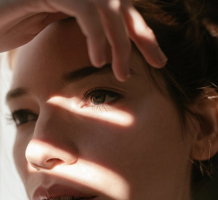 woman shielding her eyes