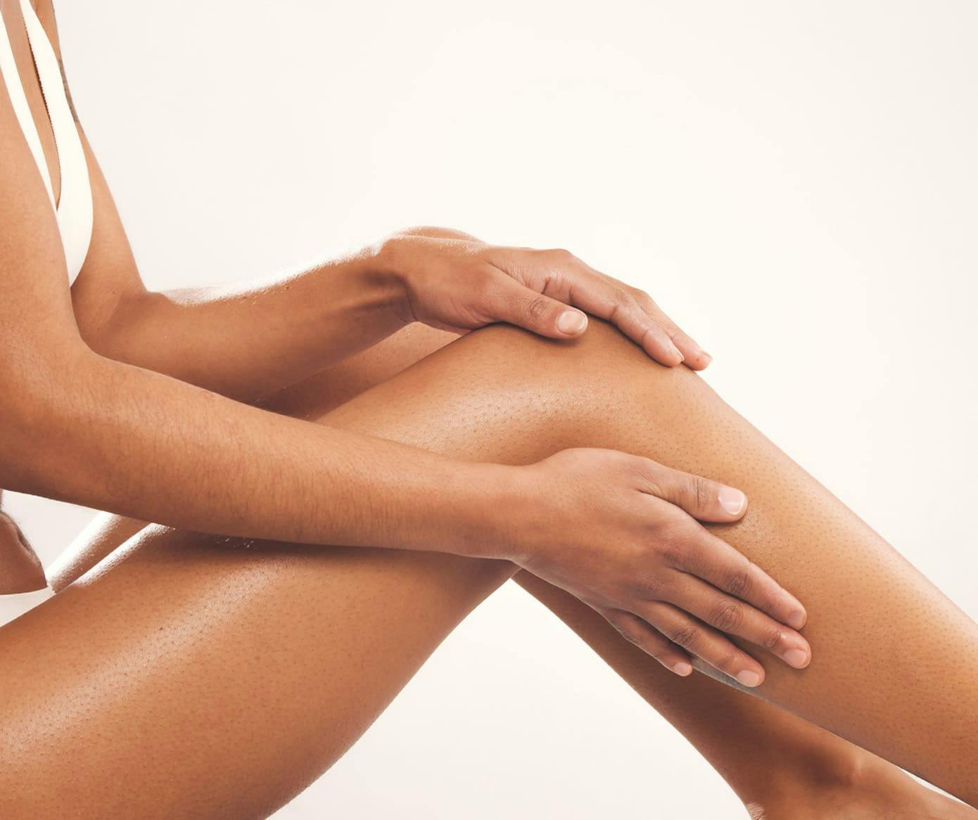 woman touching her legs