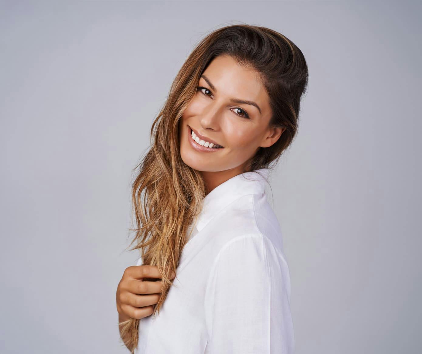woman smiling while facing to the left