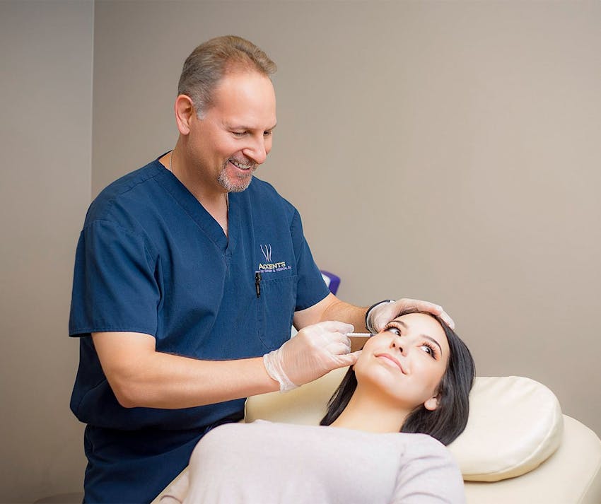 Dr. Berkowitz injecting syringe in patient
