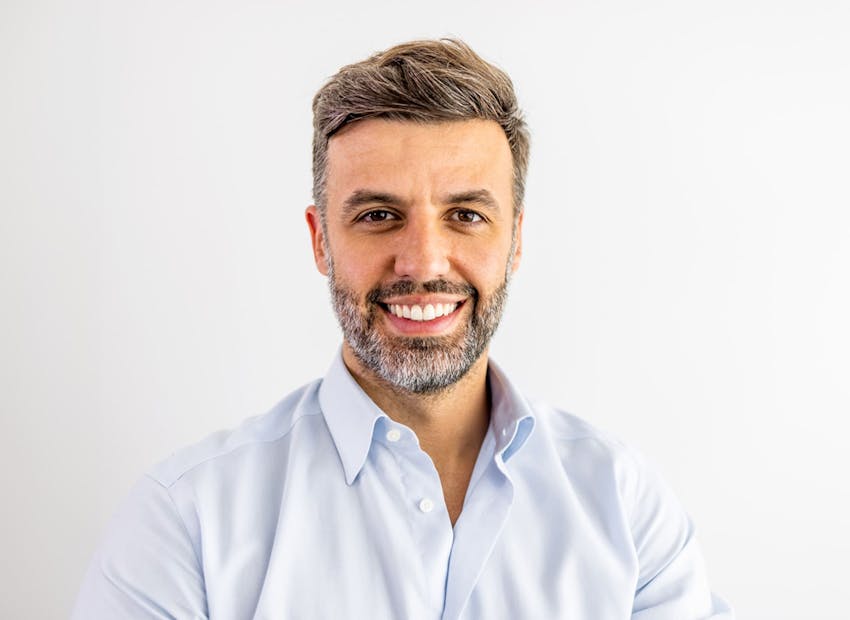 man smiling in white buttoned shirt