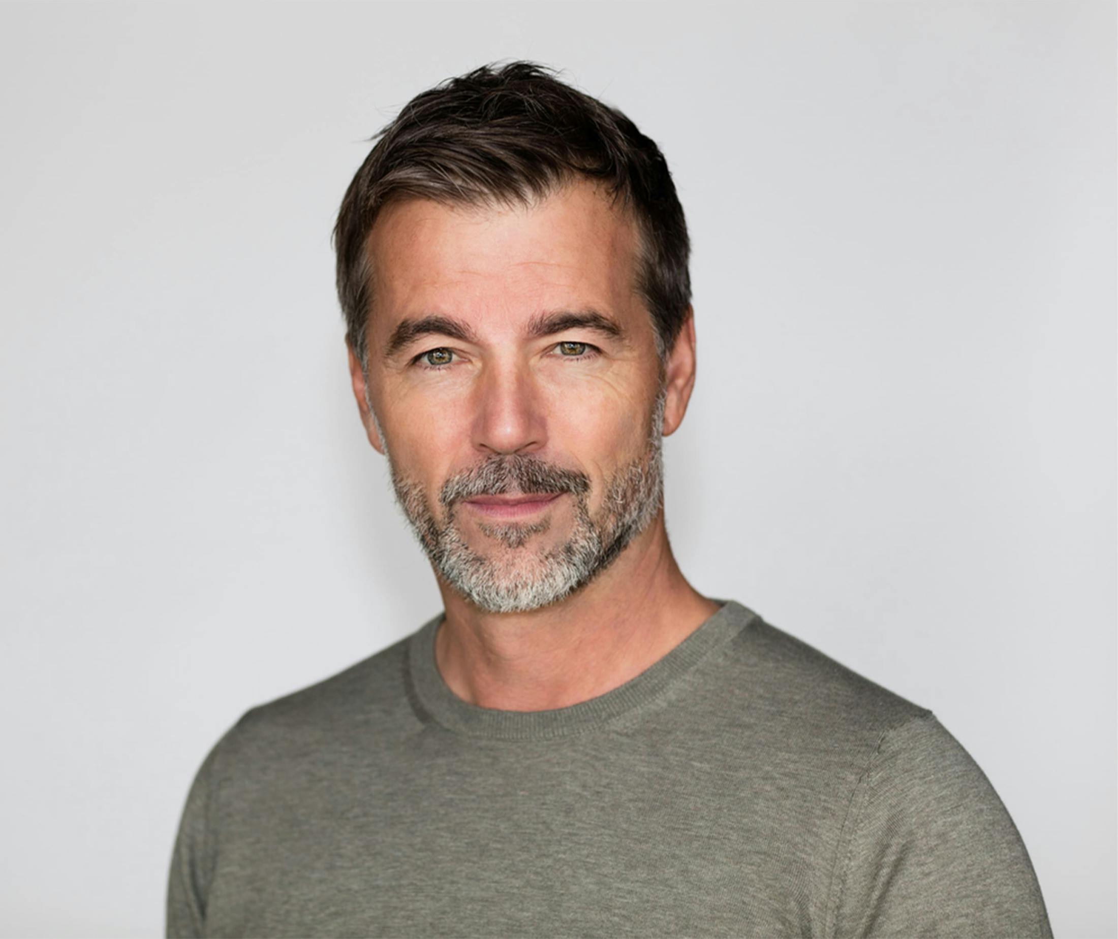 man looking forward in gray shirt