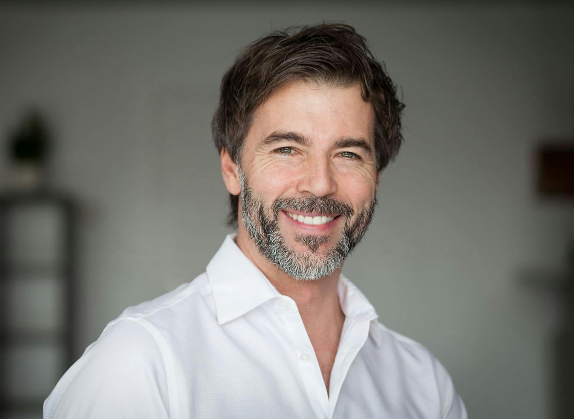 man smiling in white shirt