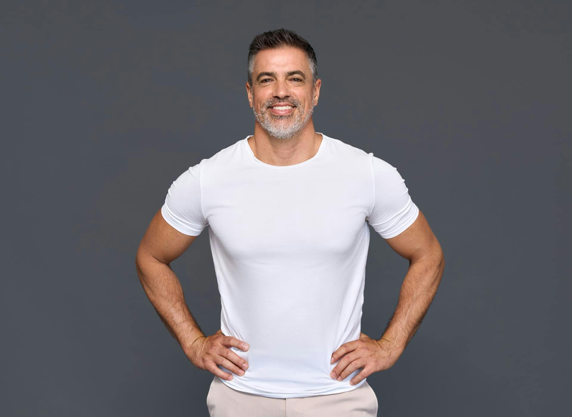 man smiling with his hands on his hips