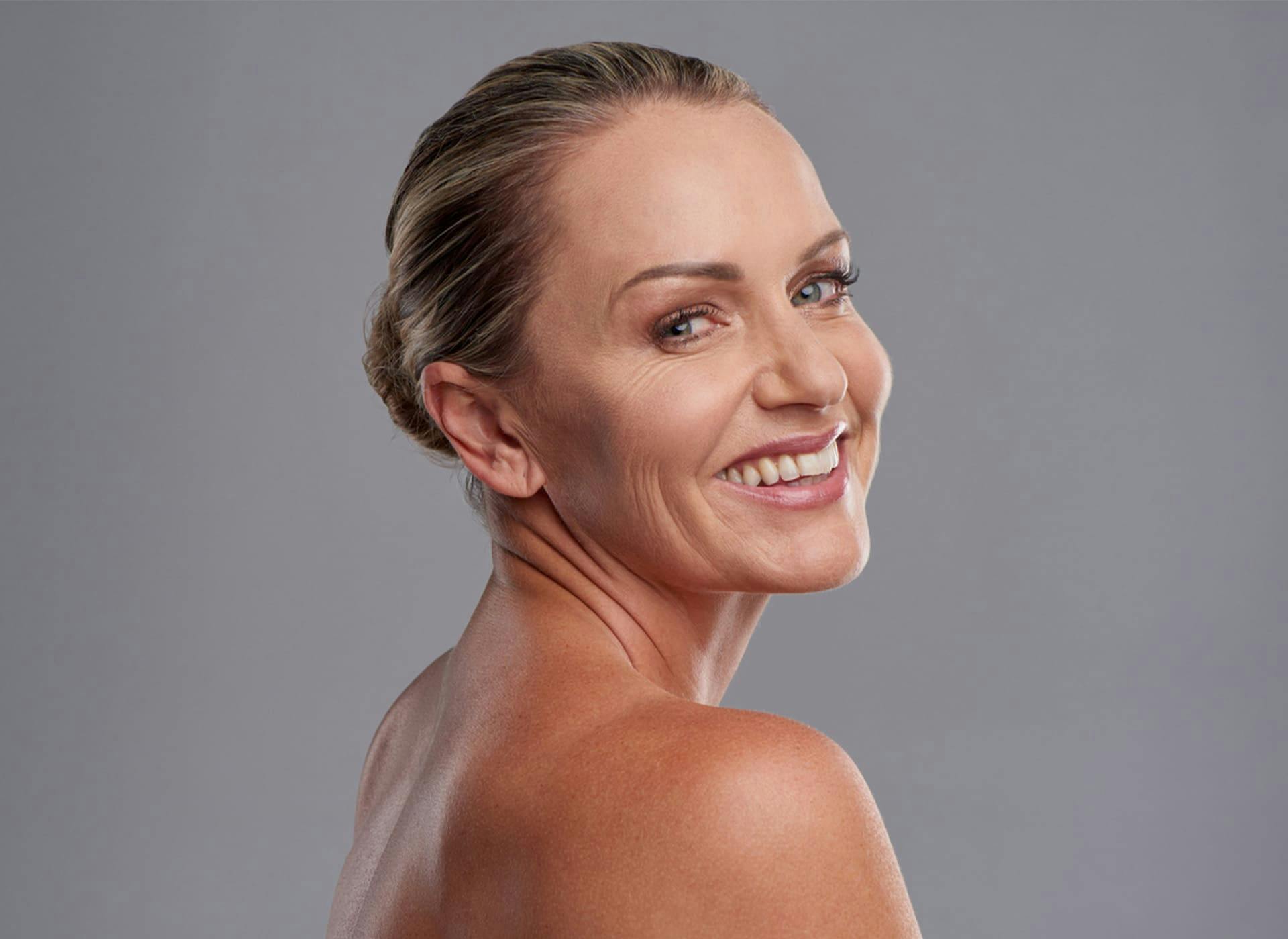 woman looking over her shoulder and smiling