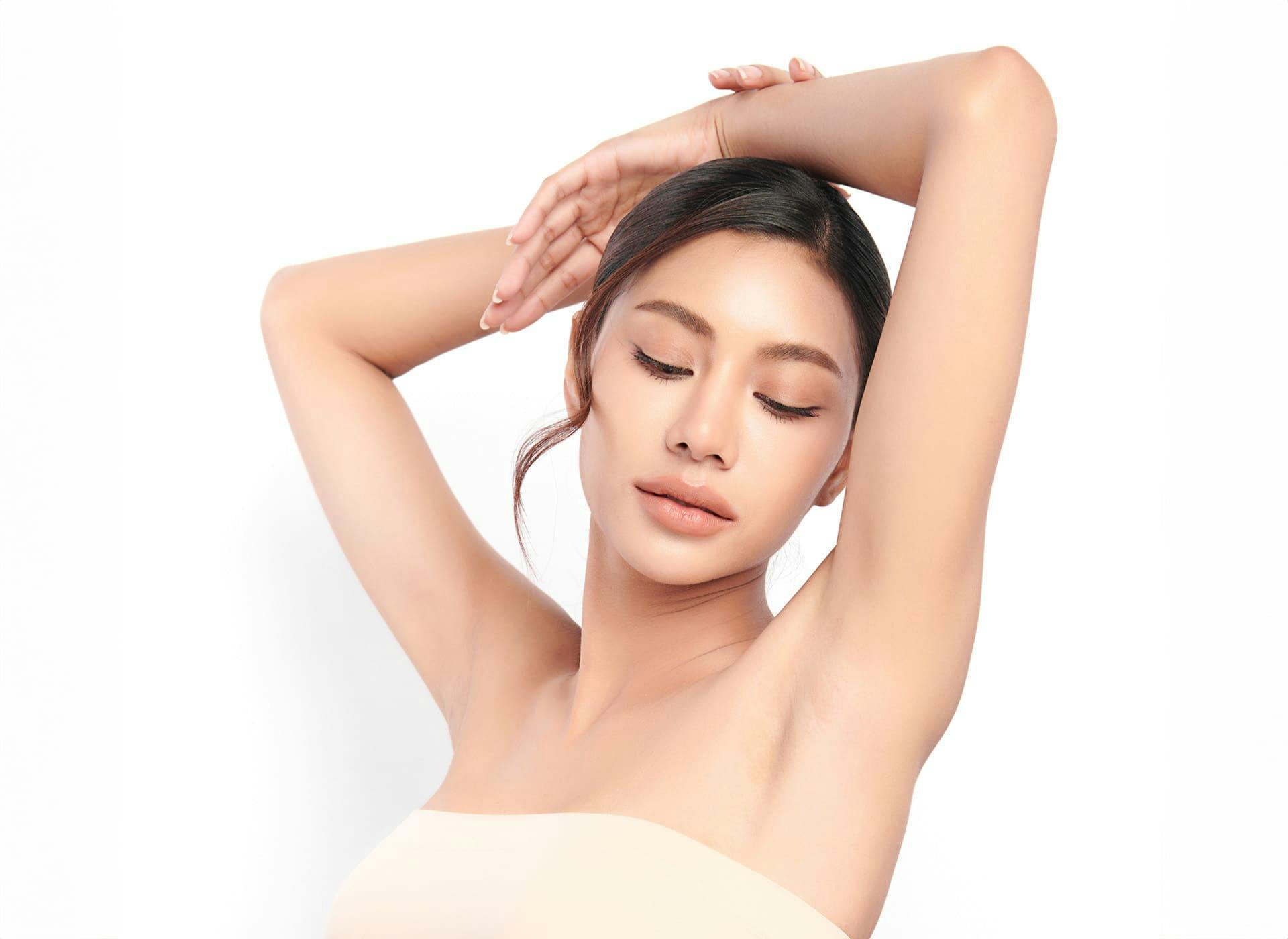 woman lifting her arms above her head