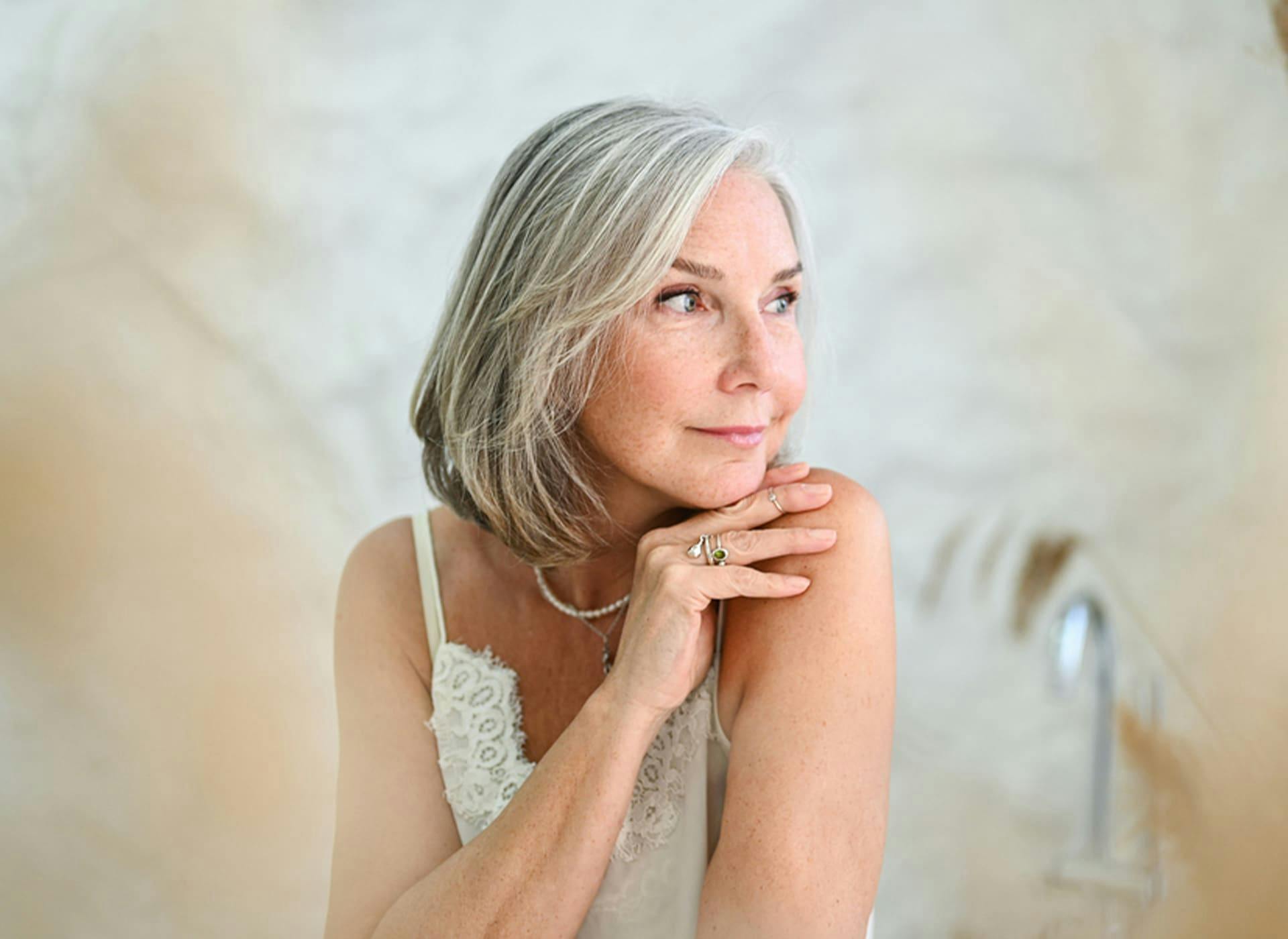 older woman with short hair looking to the right