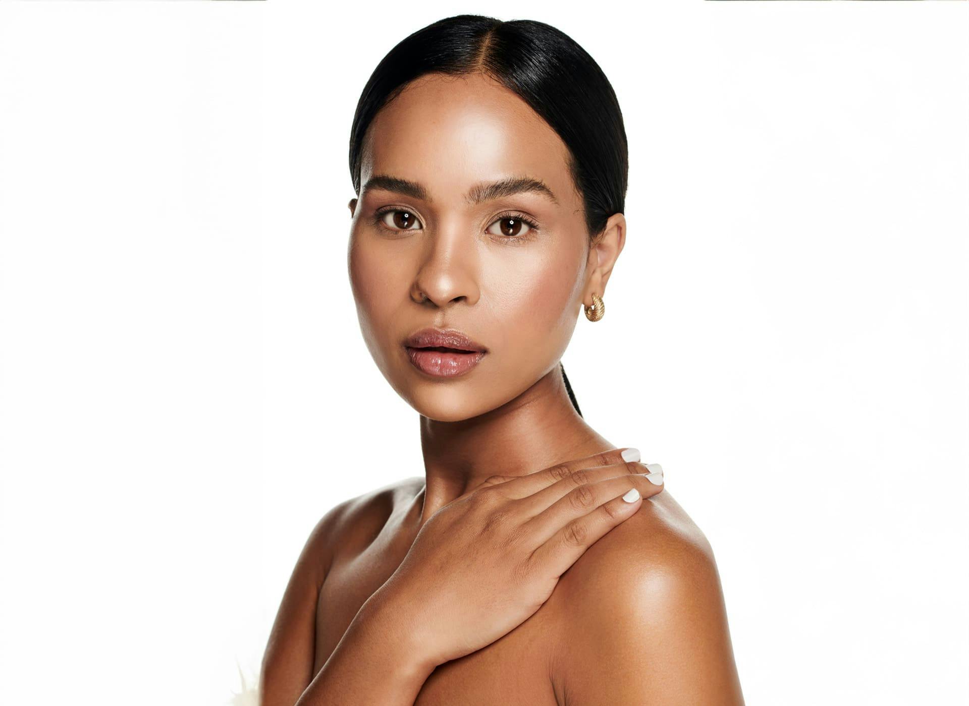 woman laying her hand on her shoulder